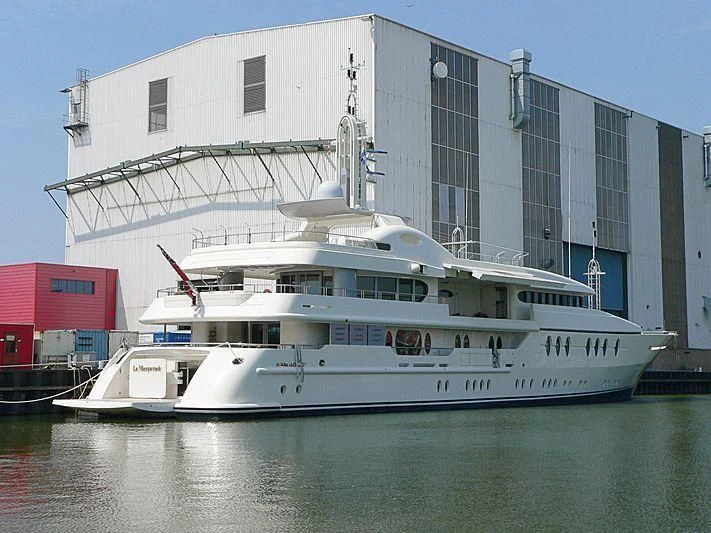 a large white boat in a harbor aboard SAMIRA Yacht for Sale