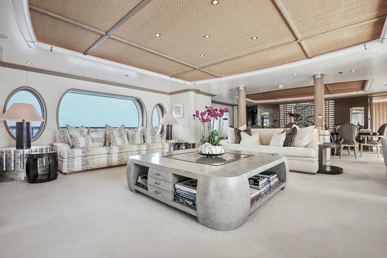 a living room with a large table aboard SAMIRA Yacht for Sale