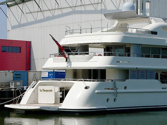 a large white boat with a red crane on the deck aboard SAMIRA Yacht for Sale