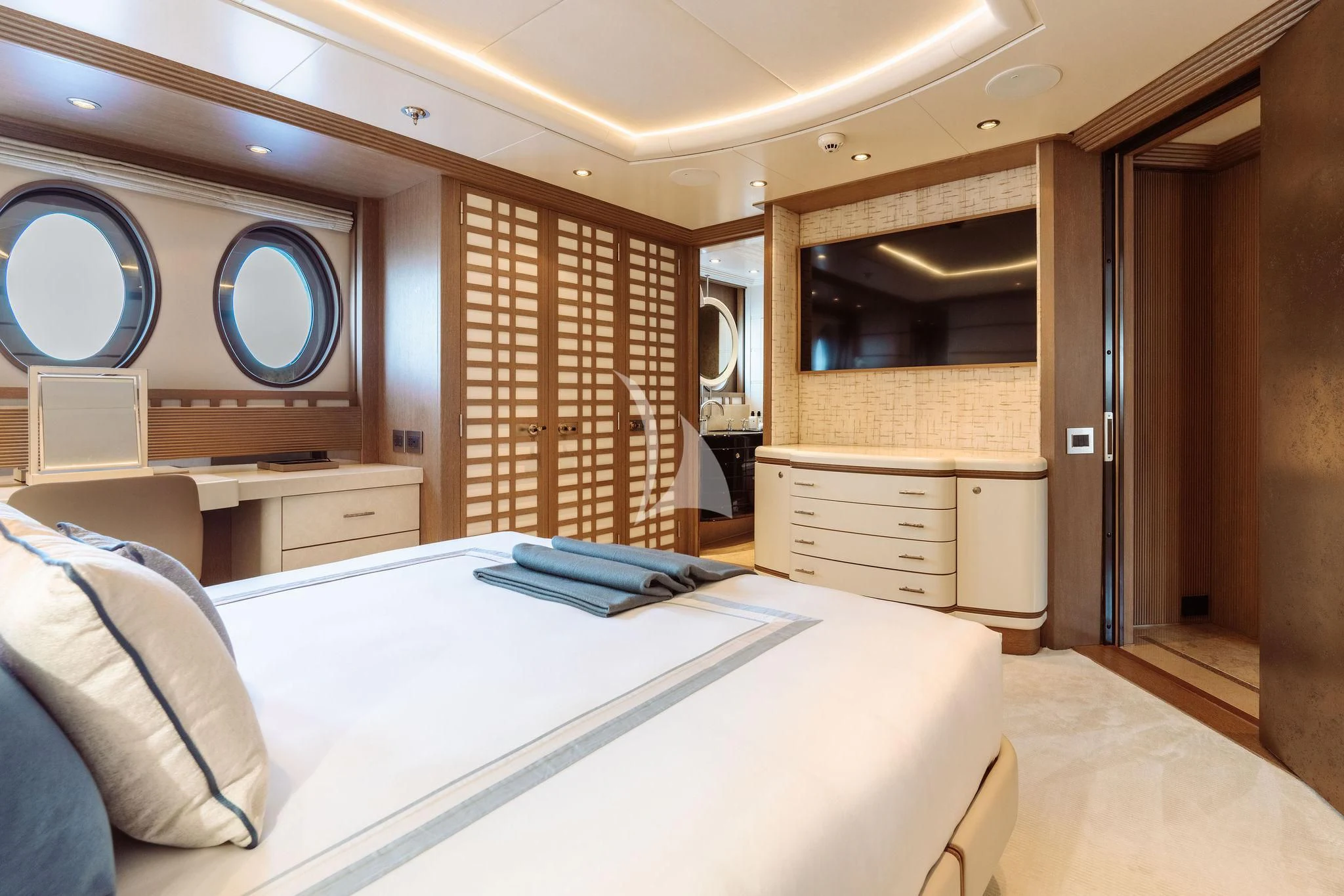 a bedroom with a bed and a mirror aboard SAMIRA Yacht for Sale