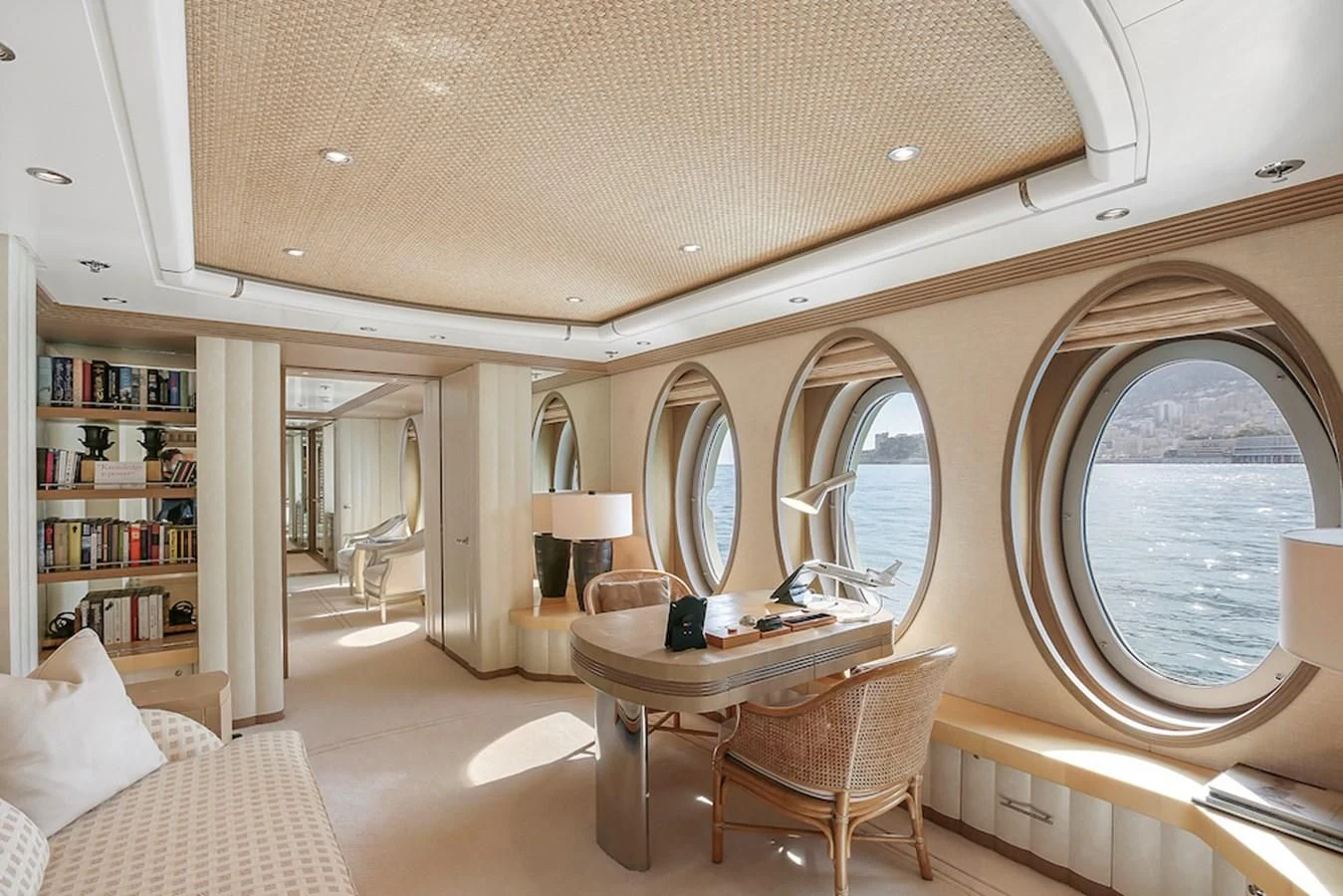 a large room with a table and chairs aboard SAMIRA Yacht for Sale