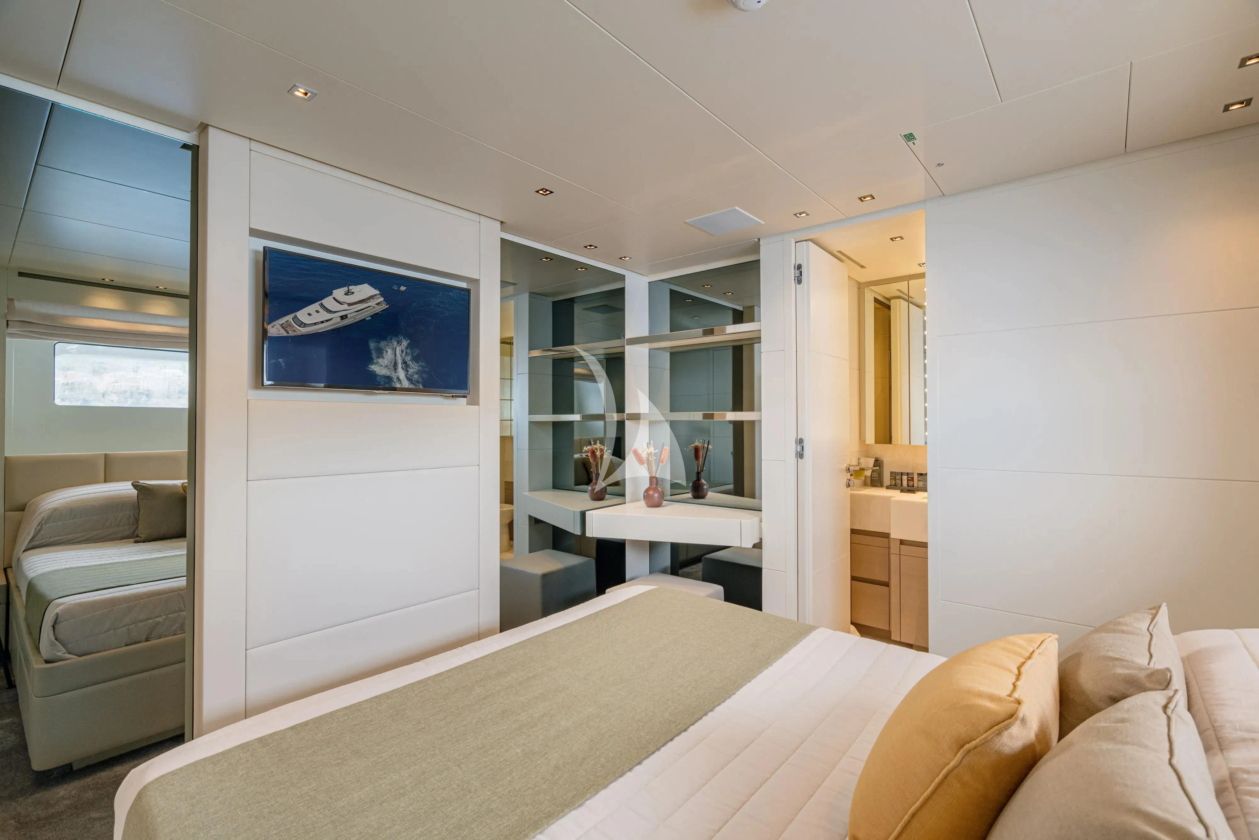 a bedroom with a bed and a desk aboard UNICKA Yacht for Sale