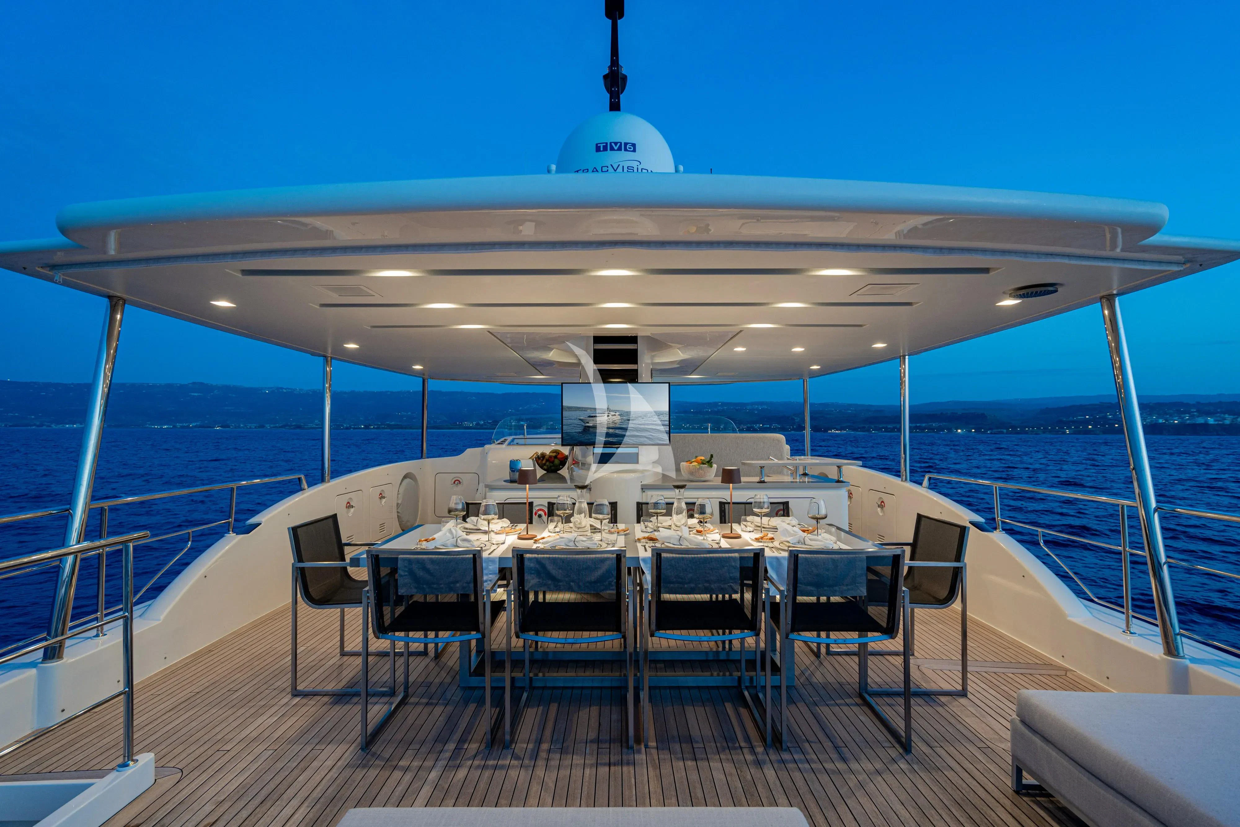 a large pool with a table and chairs on the deck aboard UNICKA Yacht for Sale