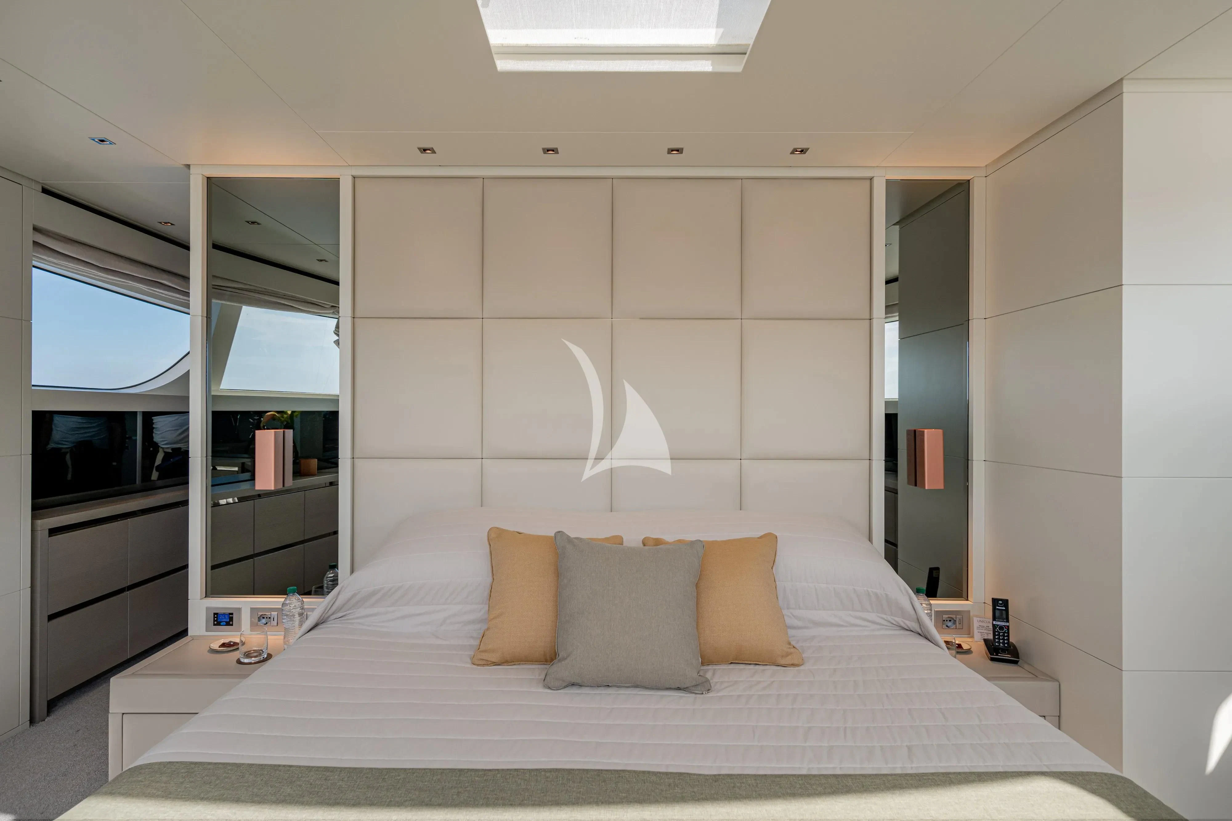 a bed with white sheets aboard UNICKA Yacht for Sale