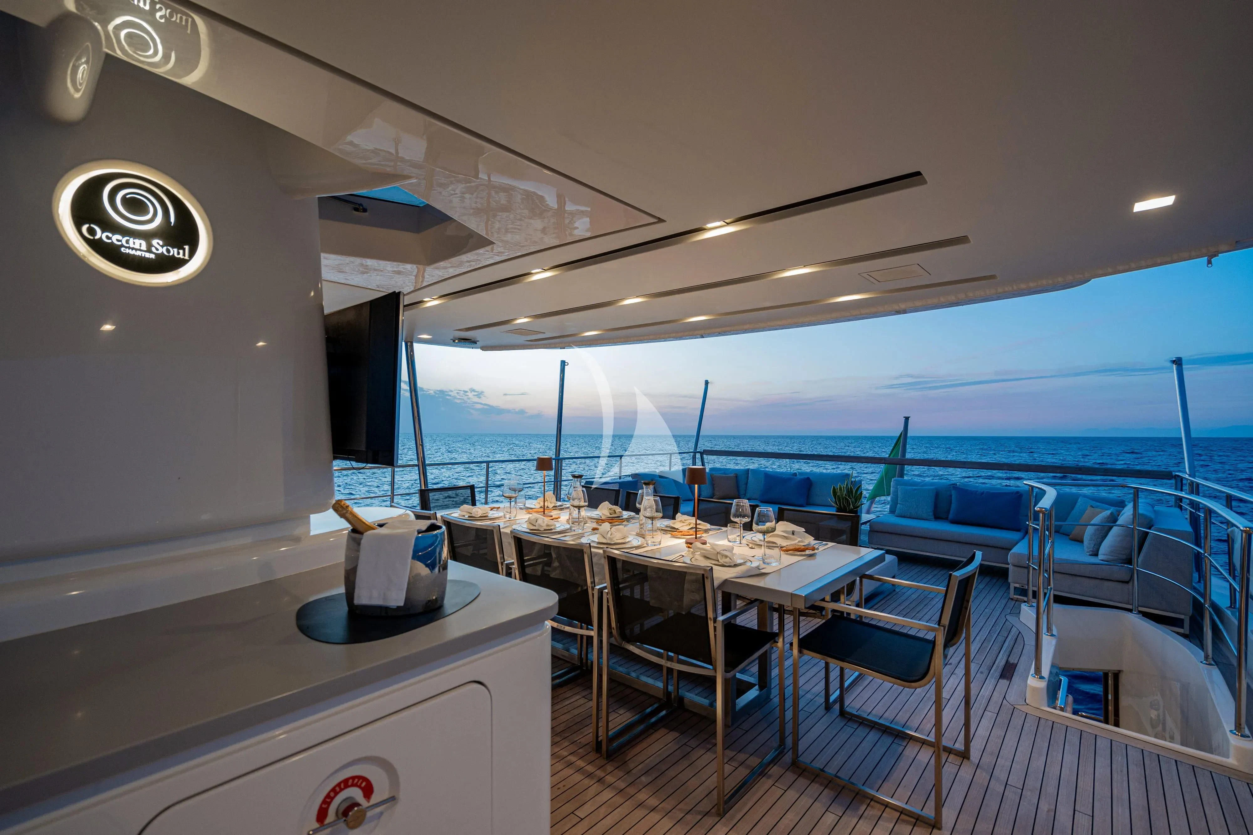 a room with tables and chairs aboard UNICKA Yacht for Sale