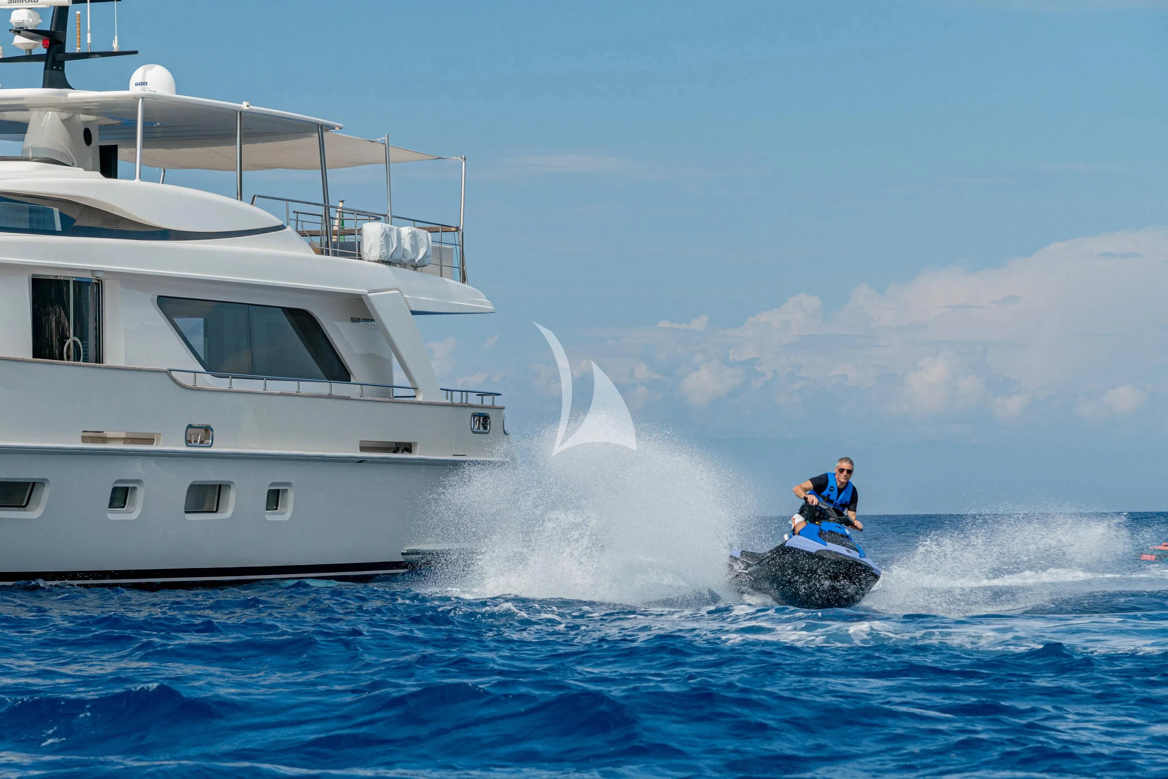 a man surfing on the waves aboard UNICKA Yacht for Sale