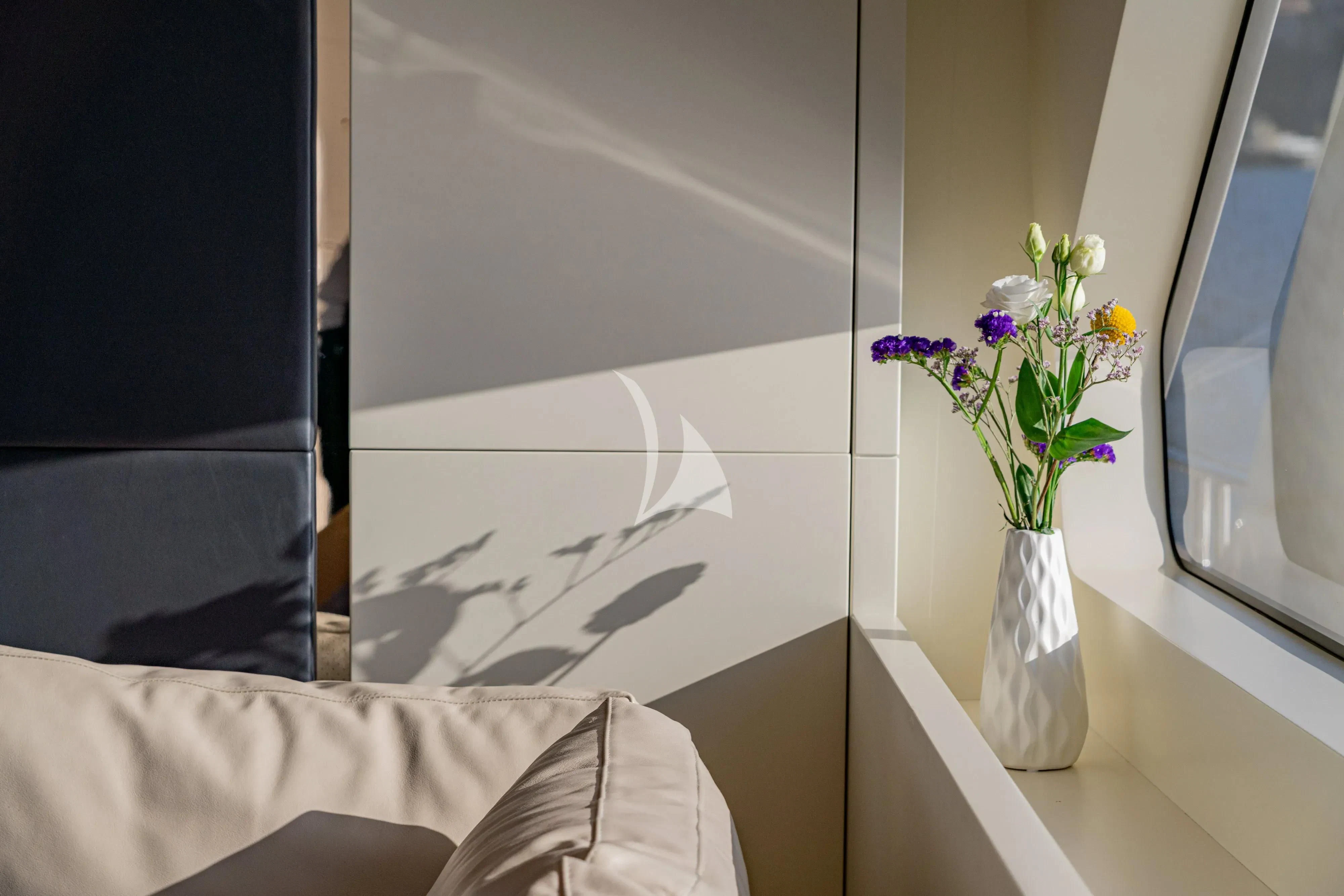 a vase with flowers on a table aboard UNICKA Yacht for Sale