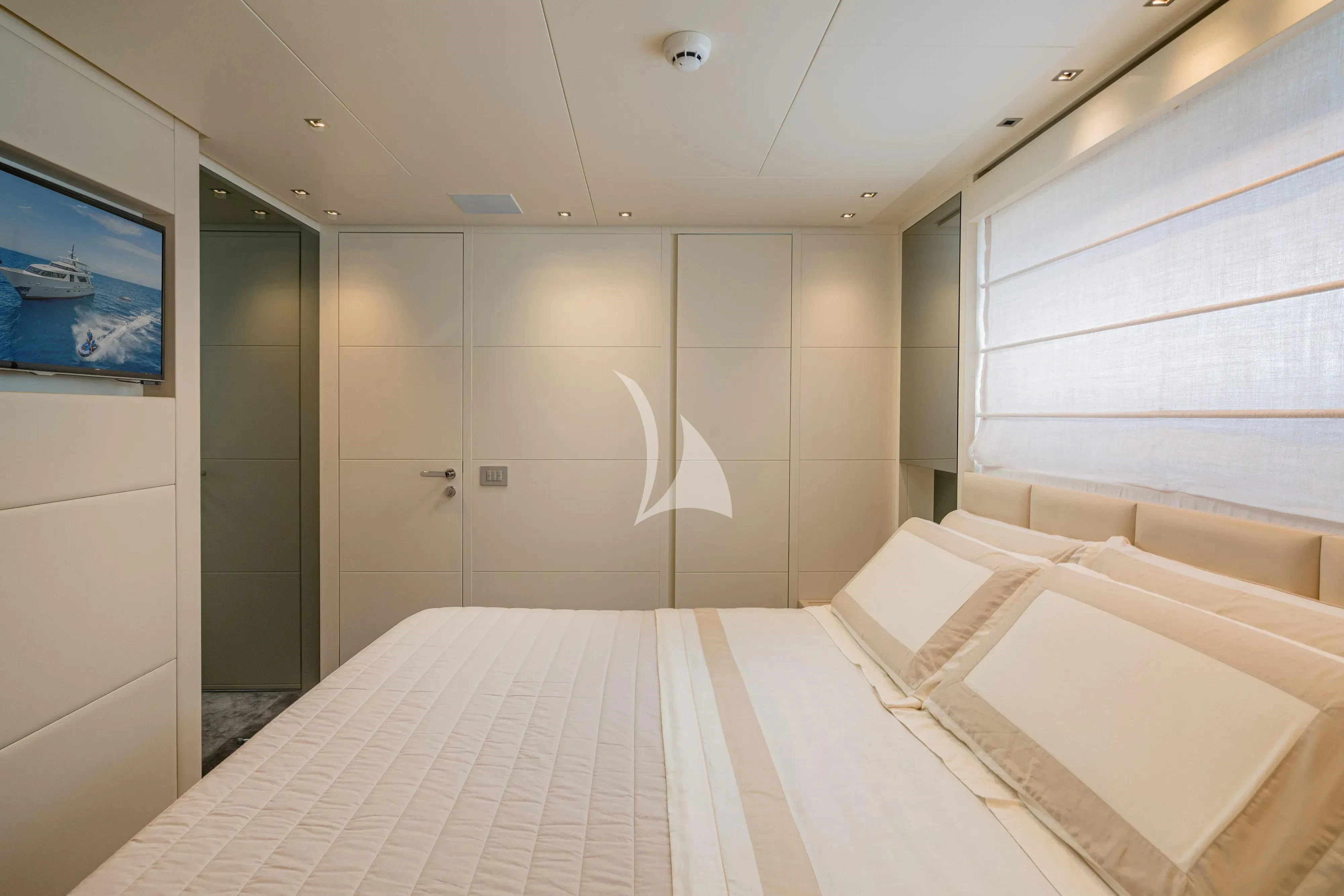 a room with a bed and a television aboard UNICKA Yacht for Sale