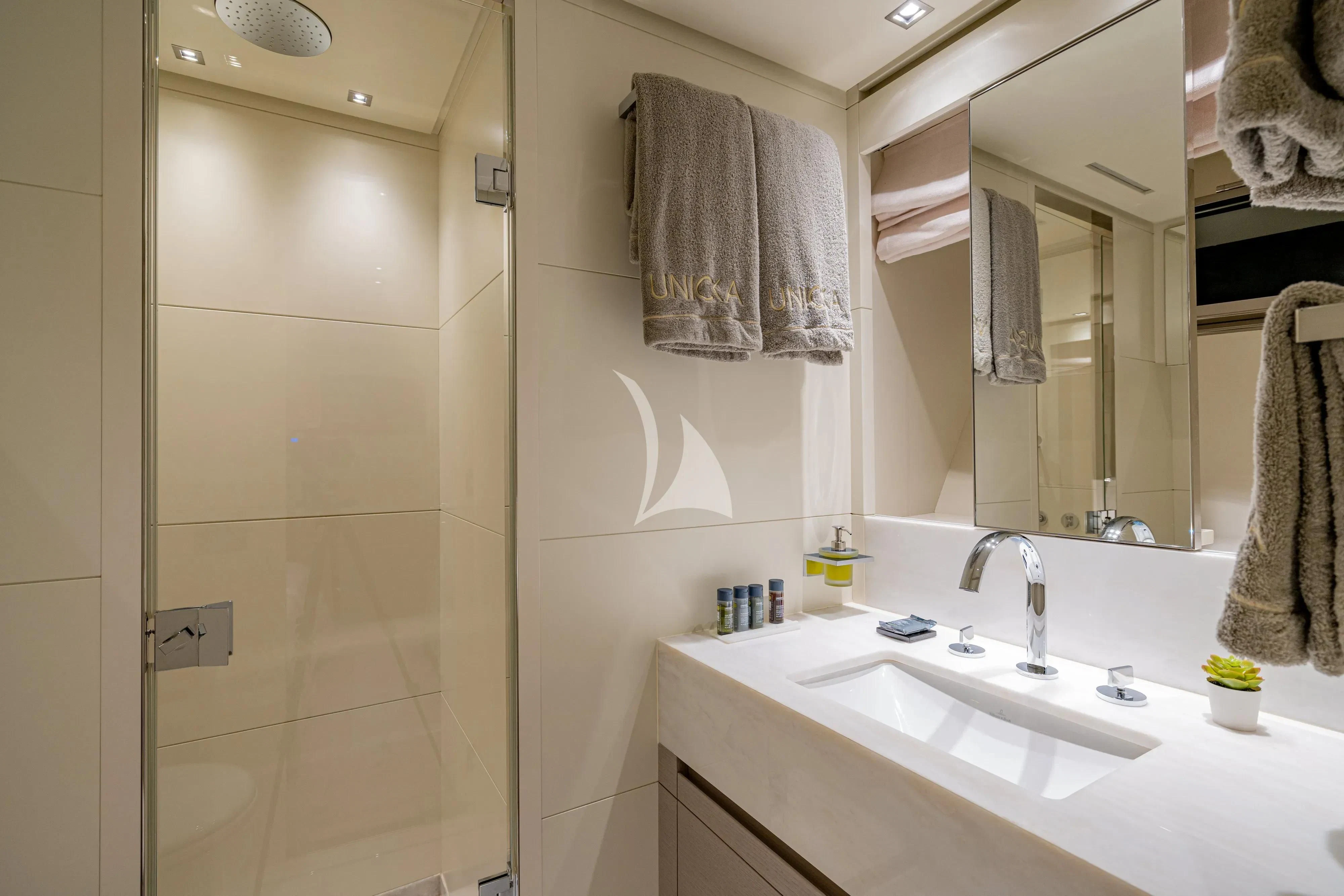 a bathroom with a sink and a mirror aboard UNICKA Yacht for Sale