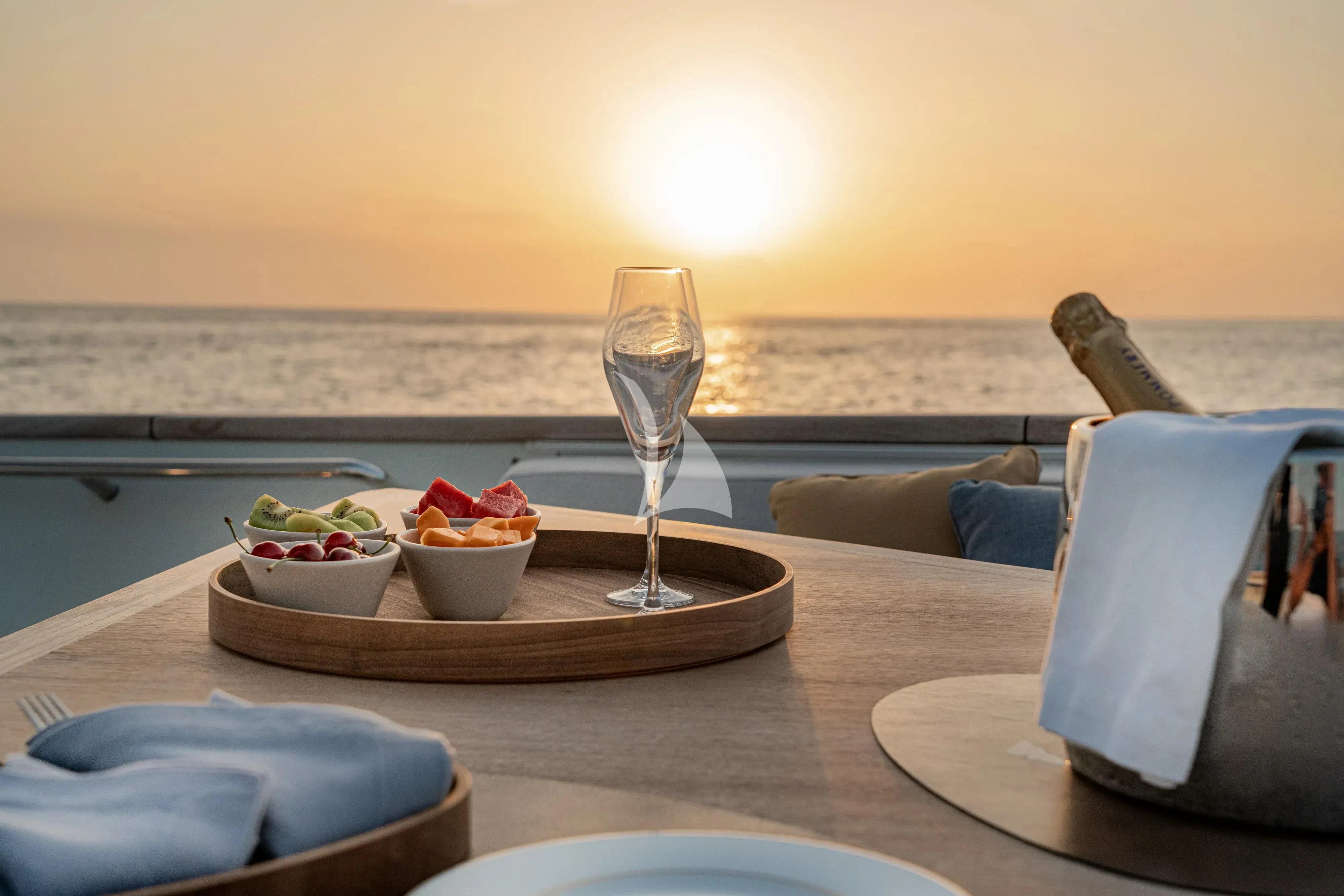 a table with food and wine aboard UNICKA Yacht for Sale