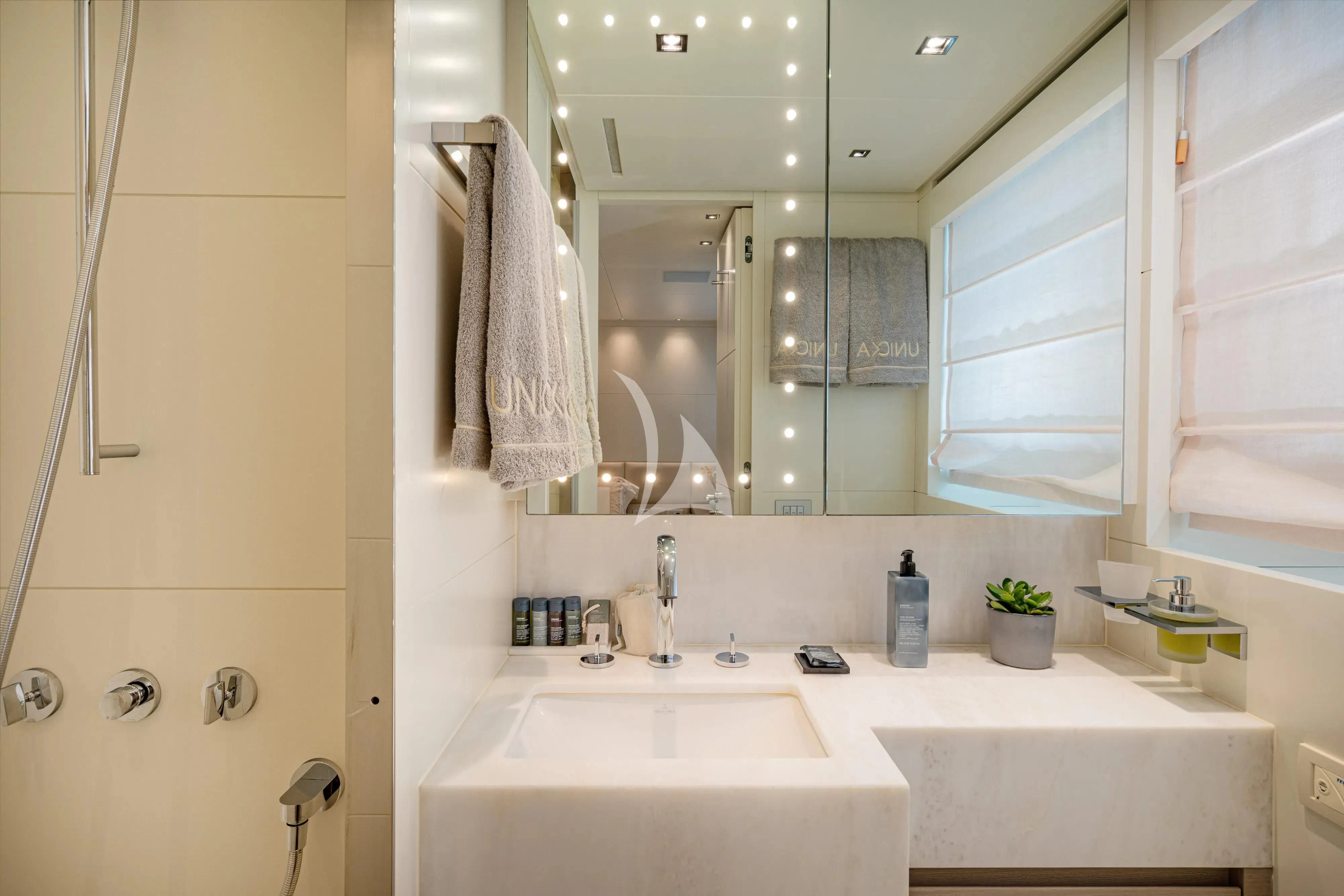 a bathroom with a large mirror aboard UNICKA Yacht for Sale
