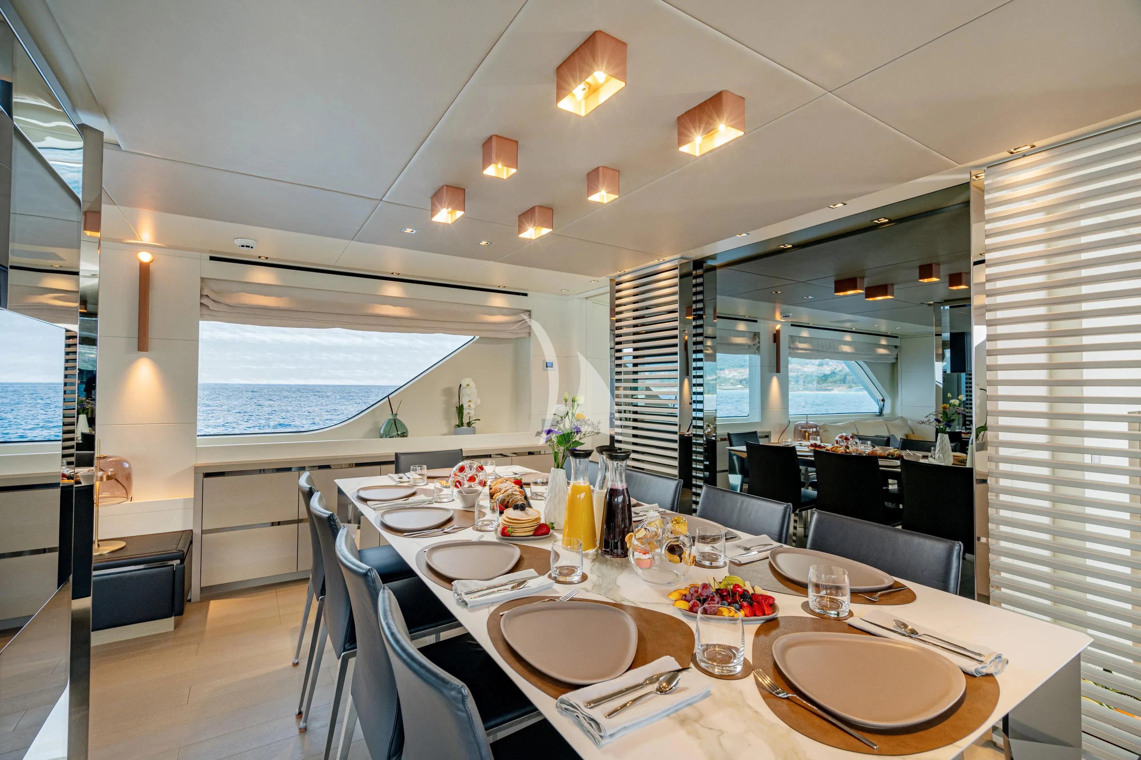 a large dining room with a large table and chairs aboard UNICKA Yacht for Sale