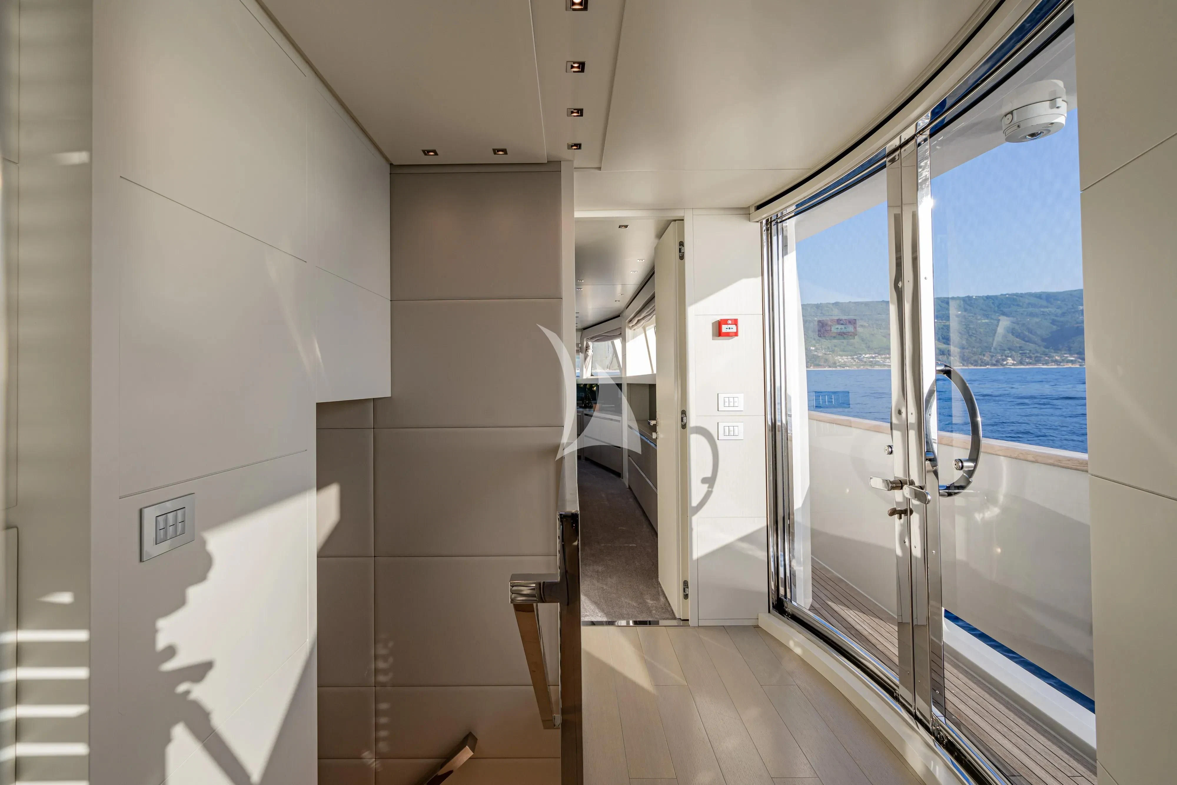 a hallway with glass doors aboard UNICKA Yacht for Sale