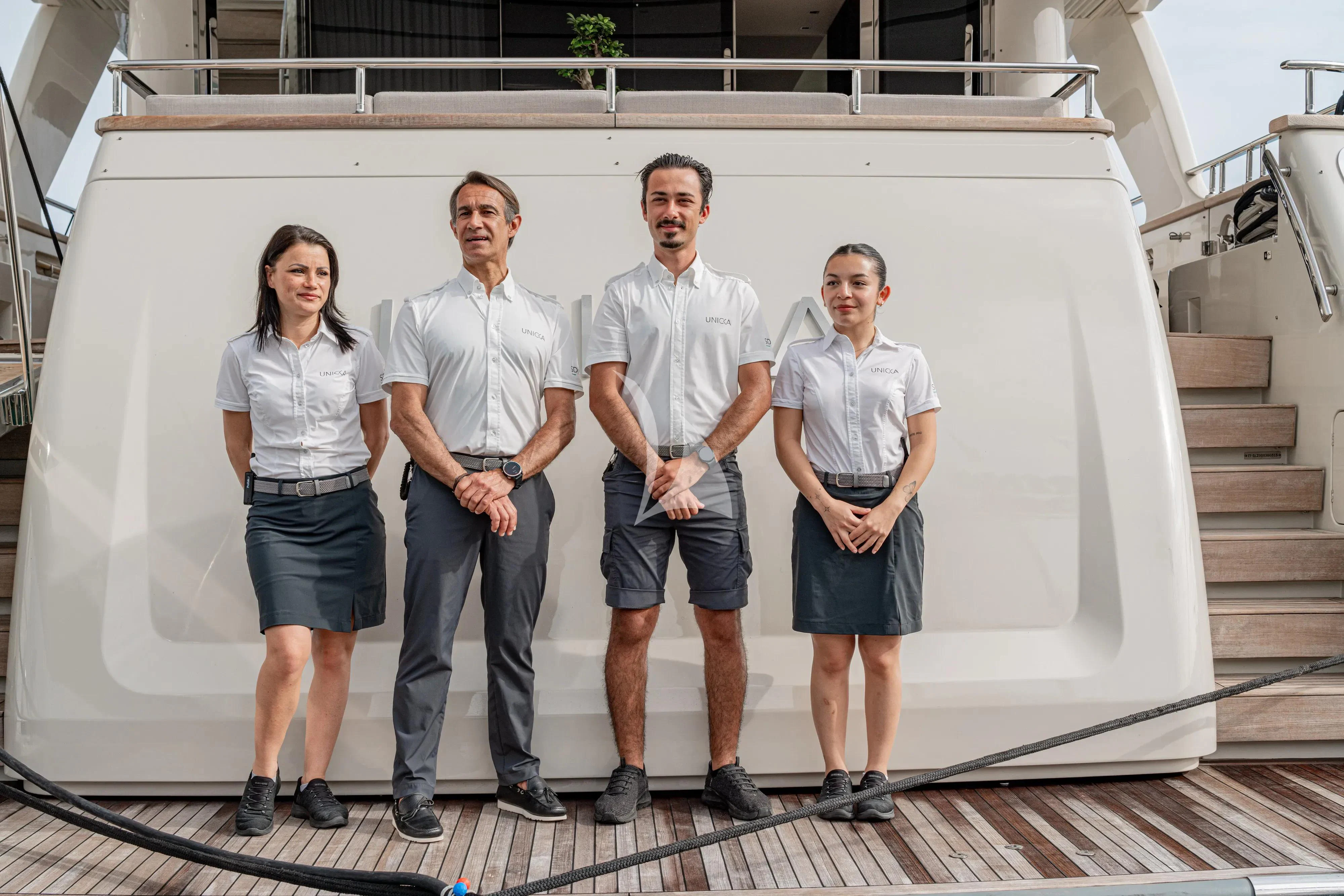 a group of people posing for a photo aboard UNICKA Yacht for Sale