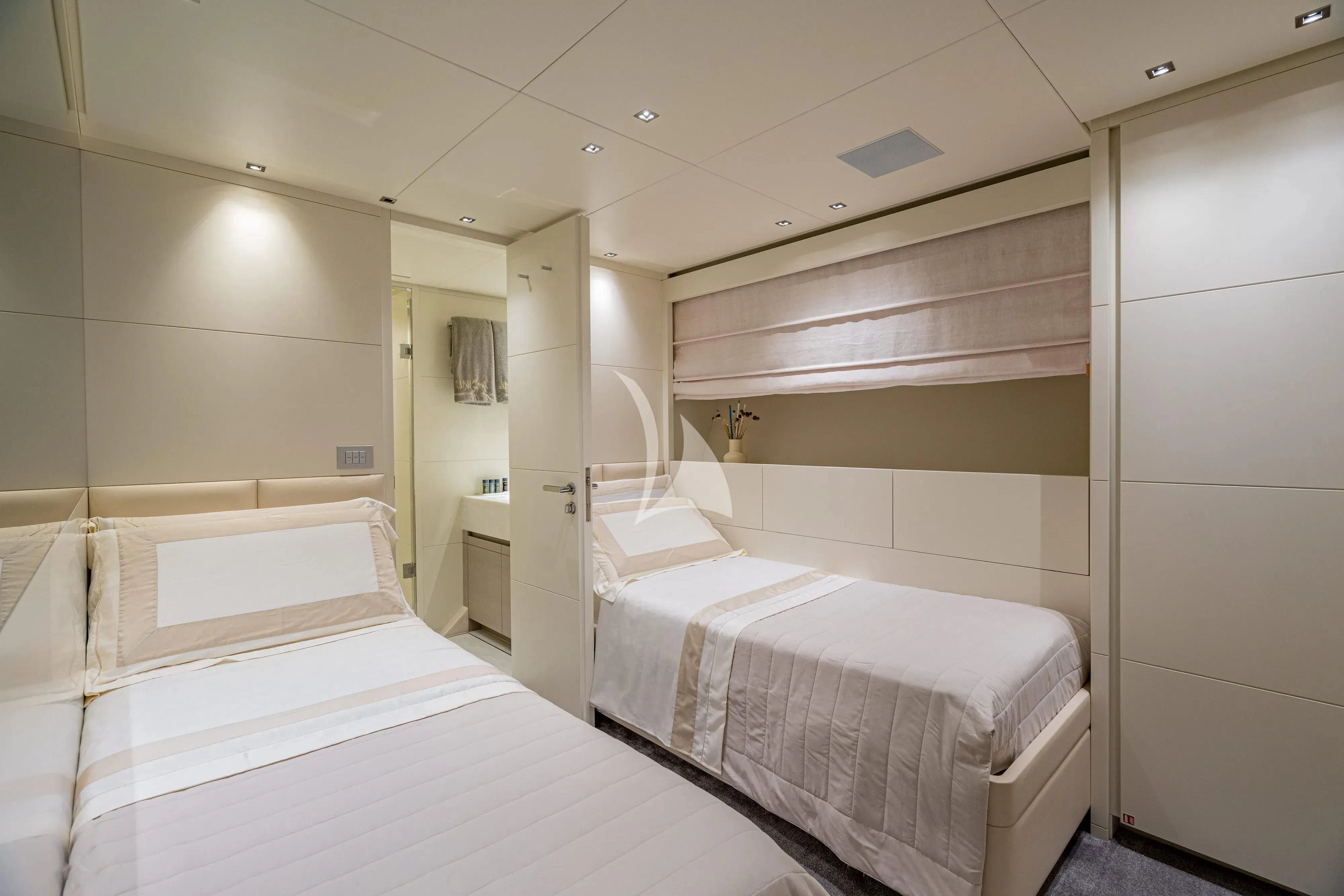 a room with two beds aboard UNICKA Yacht for Sale
