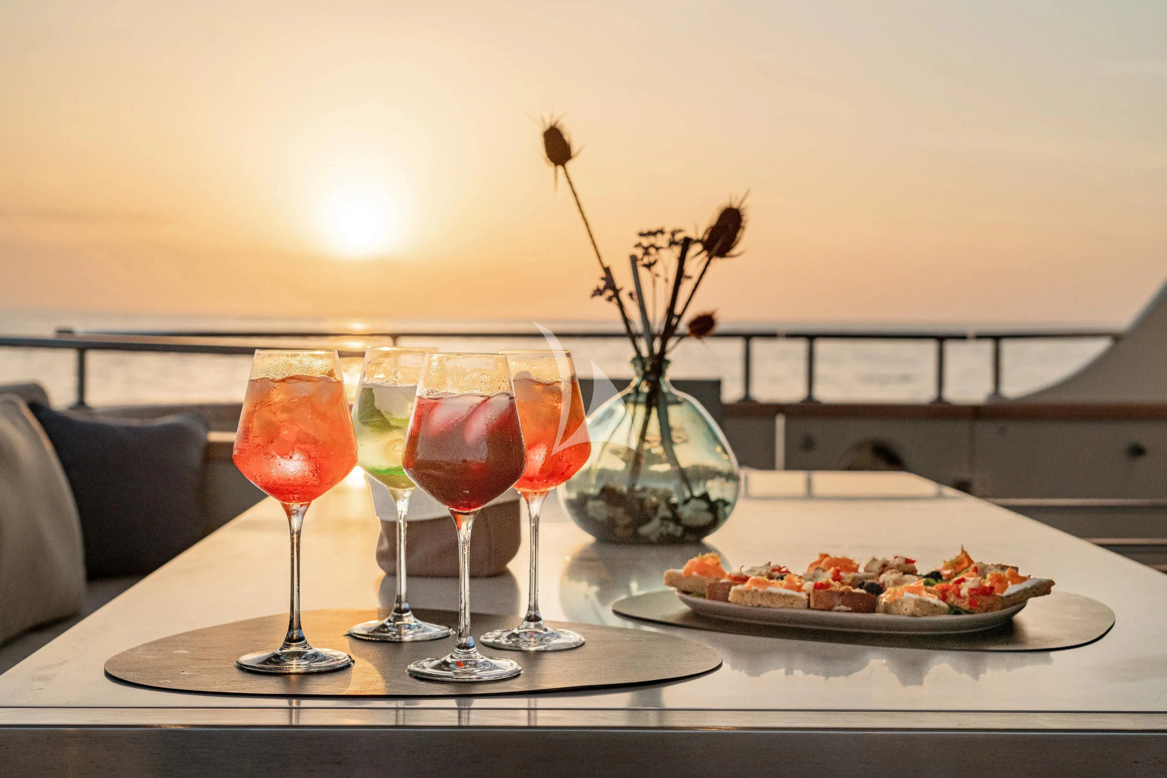 a table with food and drinks aboard UNICKA Yacht for Sale