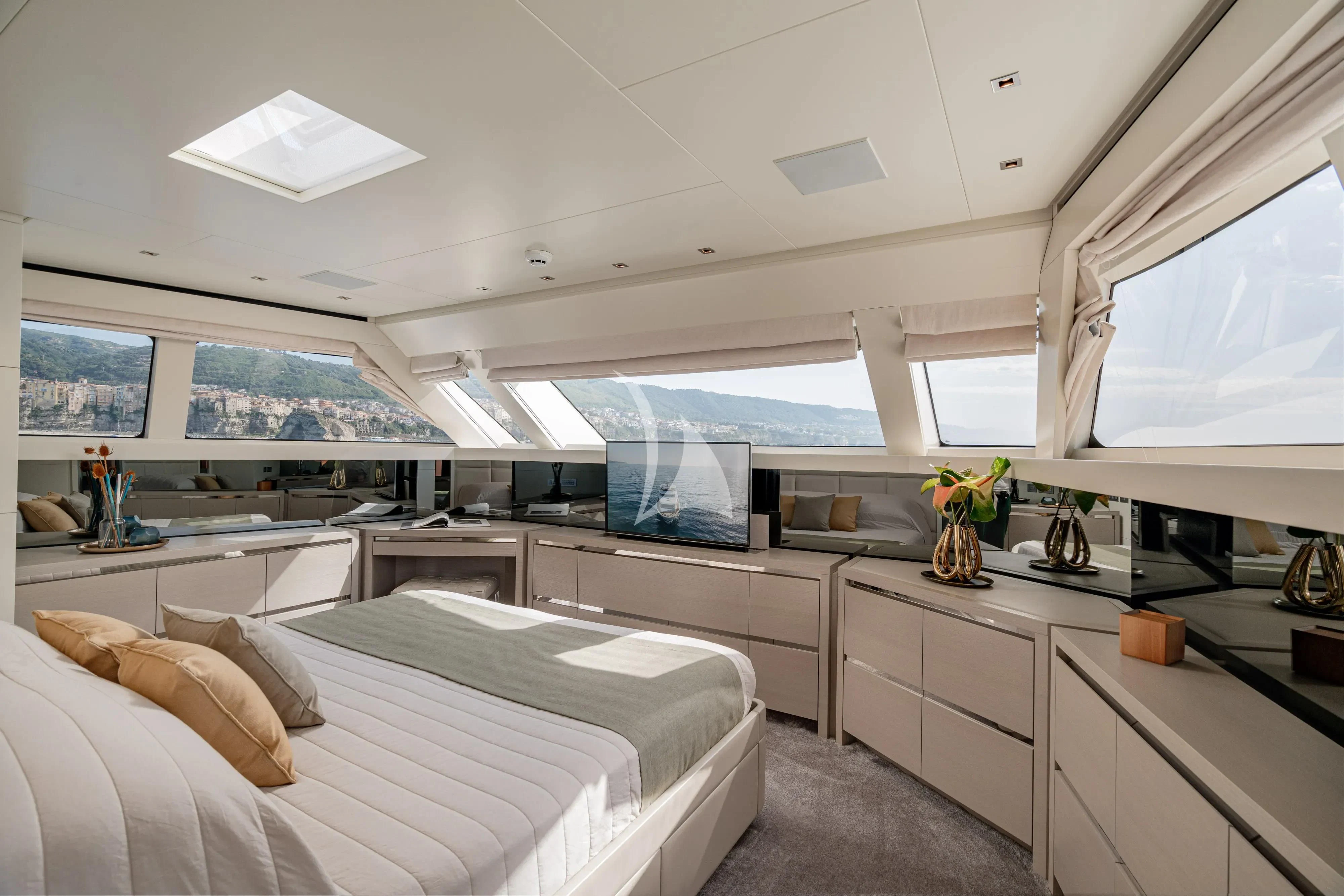 a bedroom with a large window aboard UNICKA Yacht for Sale