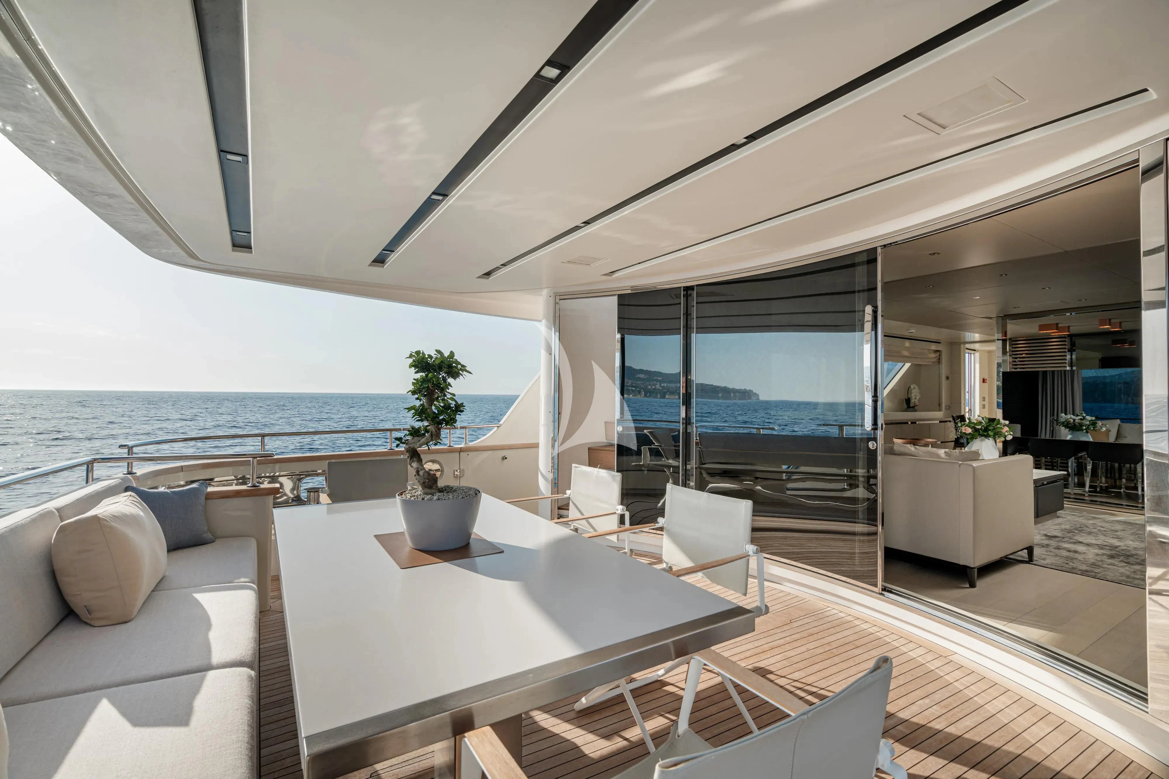 a modern living room with a large balcony overlooking the ocean aboard UNICKA Yacht for Sale