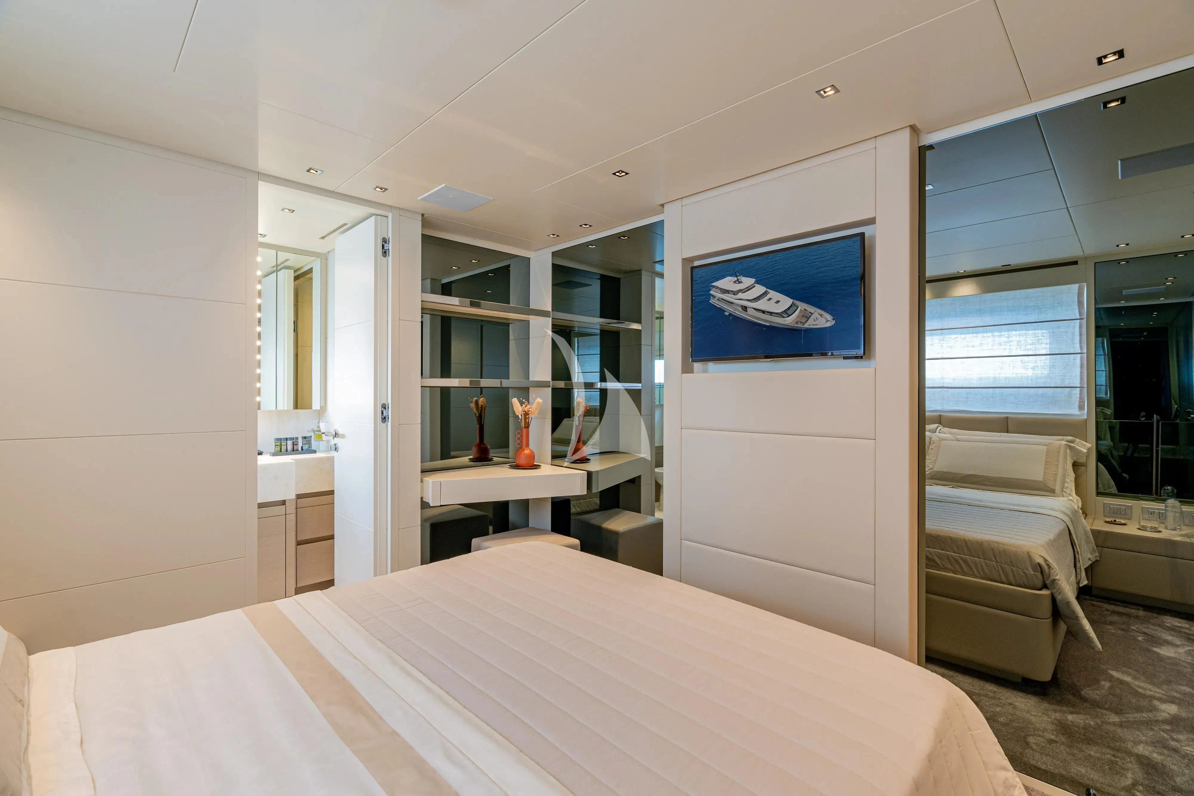 a bedroom with a bed and desk aboard UNICKA Yacht for Sale