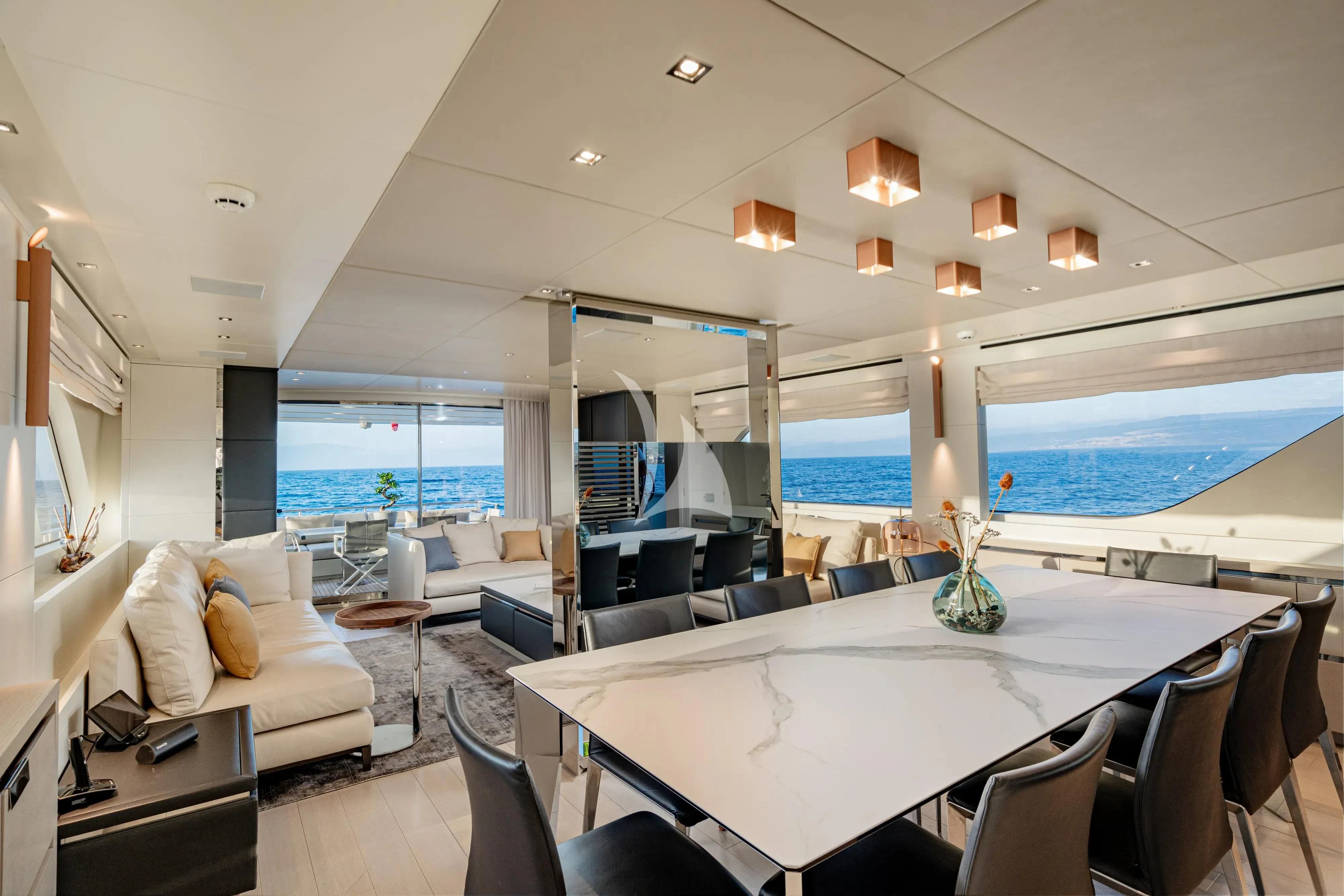 a large room with a large white table and chairs aboard UNICKA Yacht for Sale
