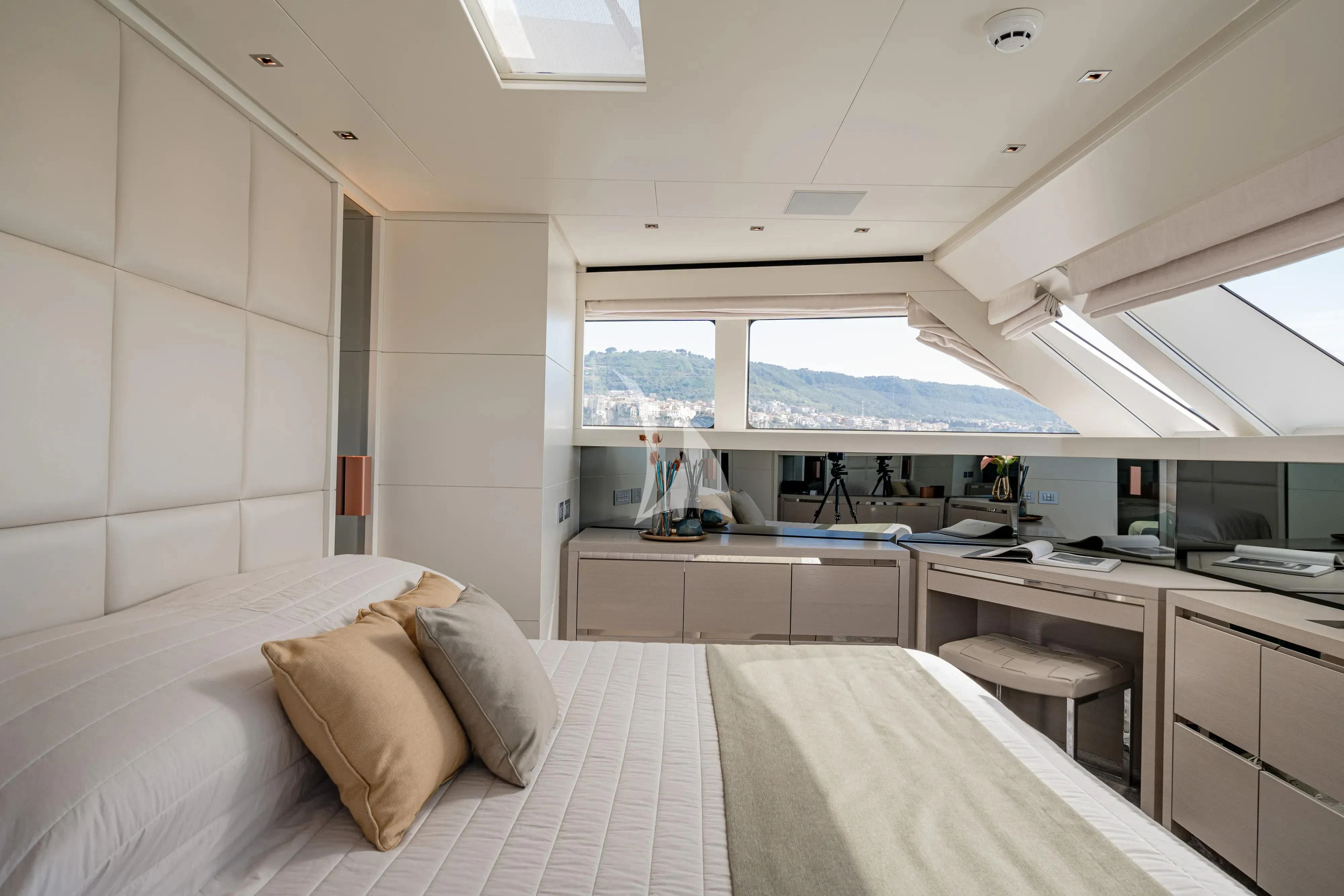 a room with a bed and a desk aboard UNICKA Yacht for Sale
