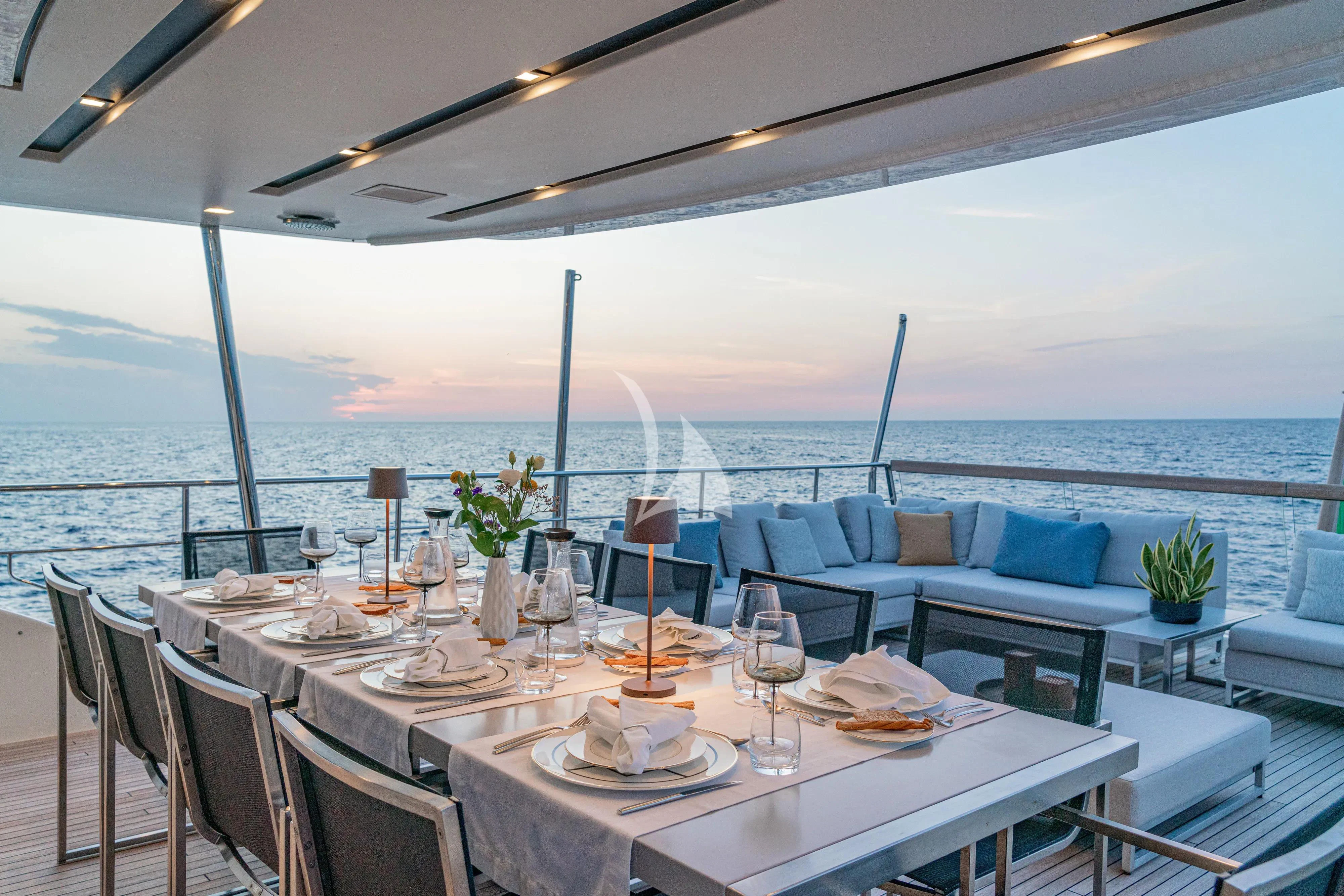 a table set for a meal on a boat aboard UNICKA Yacht for Sale