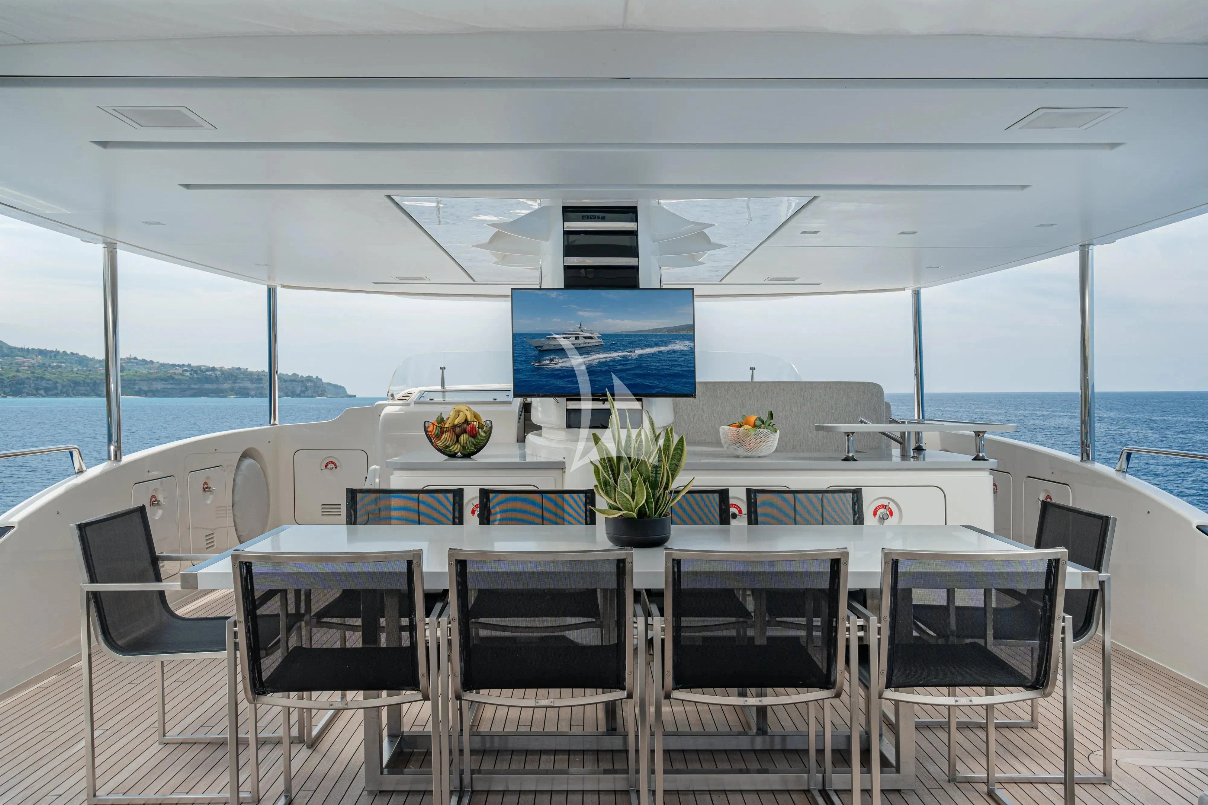 a table with chairs around it aboard UNICKA Yacht for Sale