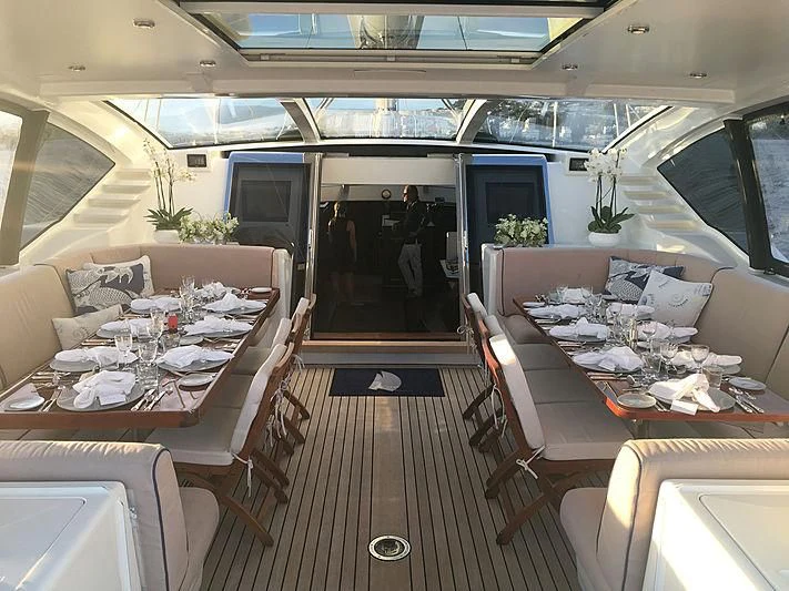 a train car with tables and chairs aboard LA BELLE Yacht for Sale