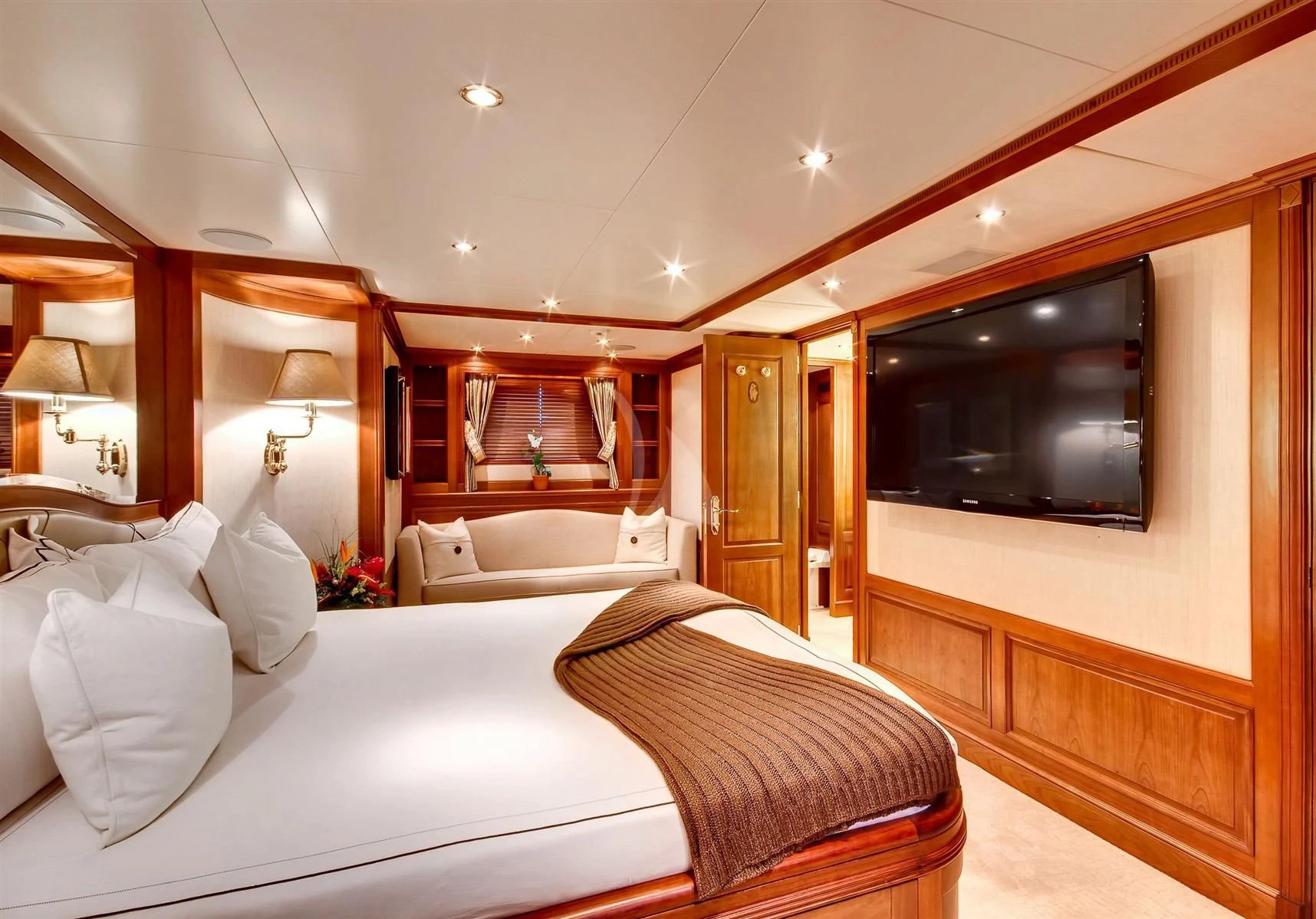 a hotel room with a bed and a television aboard KEIKI KAI Yacht for Sale