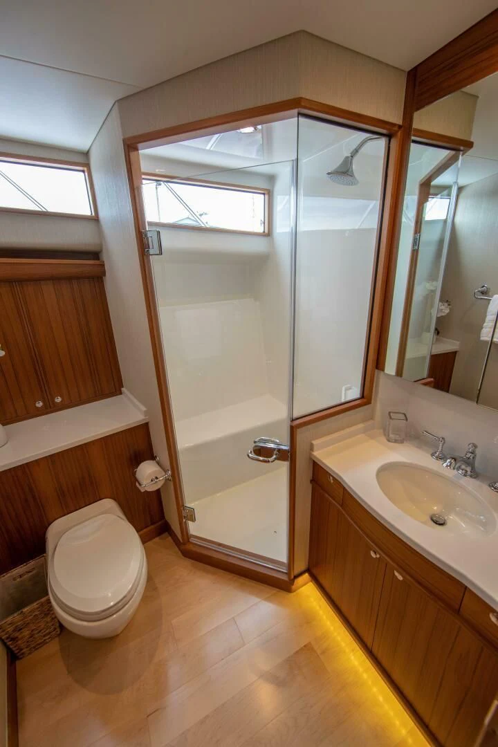 a bathroom with a glass shower door aboard PRIVATEER Yacht for Sale