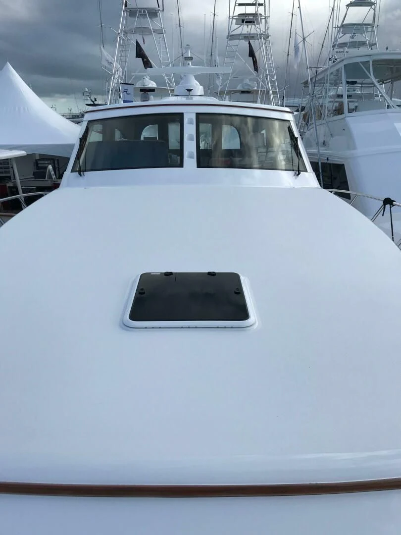 a white yacht with a black seat aboard PRIVATEER Yacht for Sale
