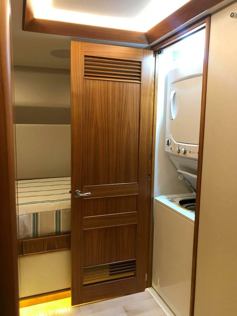 a closet with a sink and a mirror aboard PRIVATEER Yacht for Sale