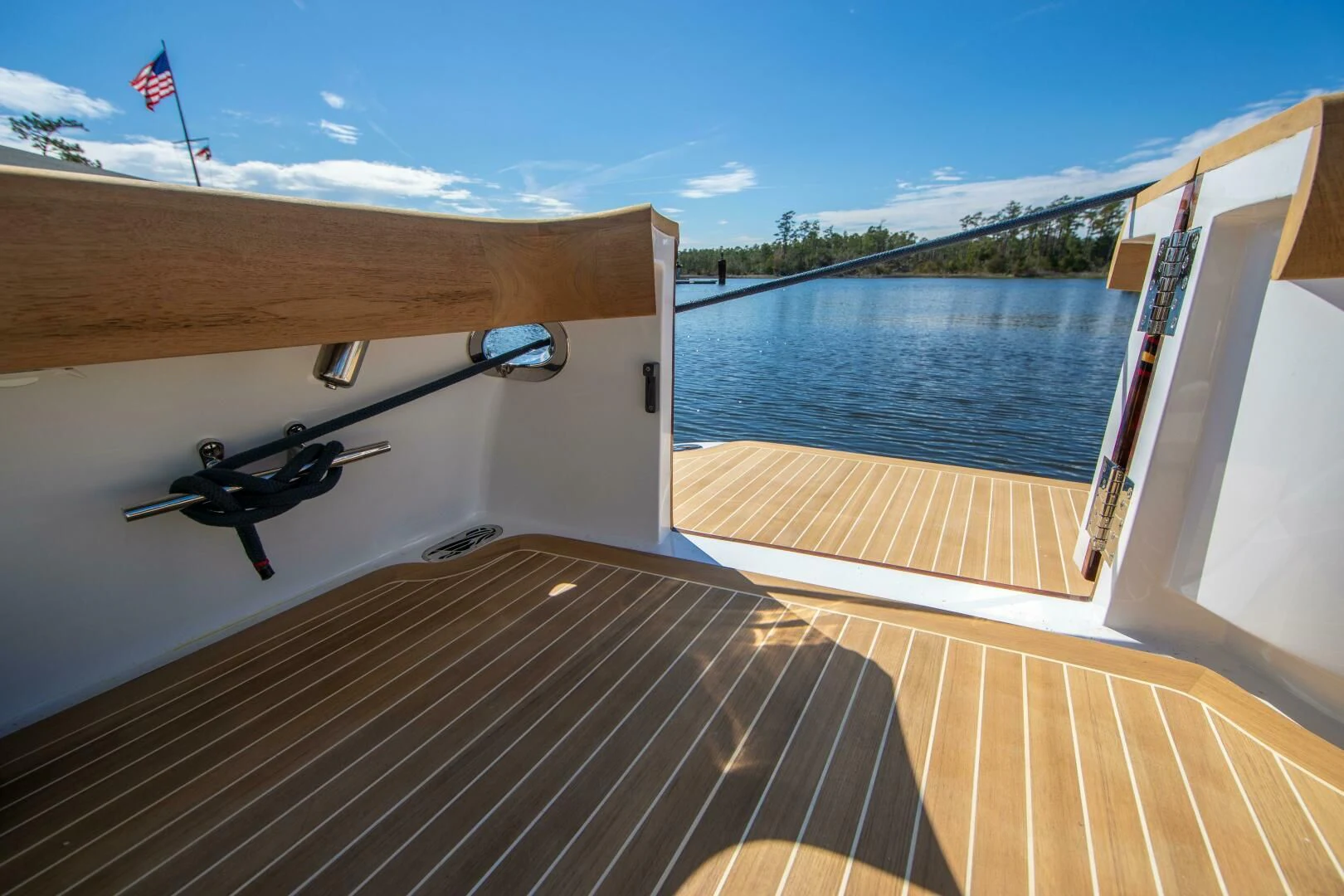 a deck with a helicopter and a flag on it aboard PRIVATEER Yacht for Sale