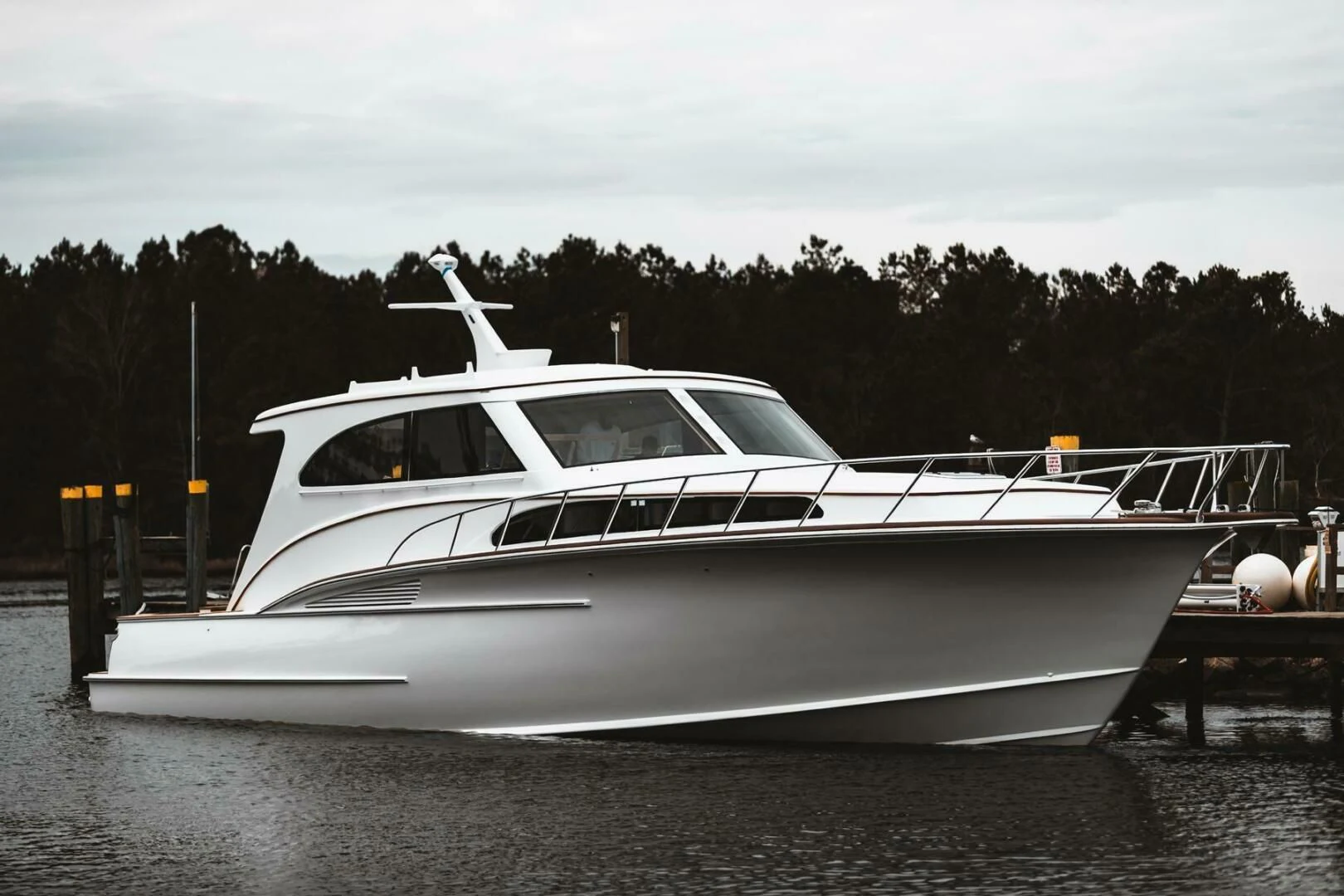 a white yacht on a dock aboard PRIVATEER Yacht for Sale
