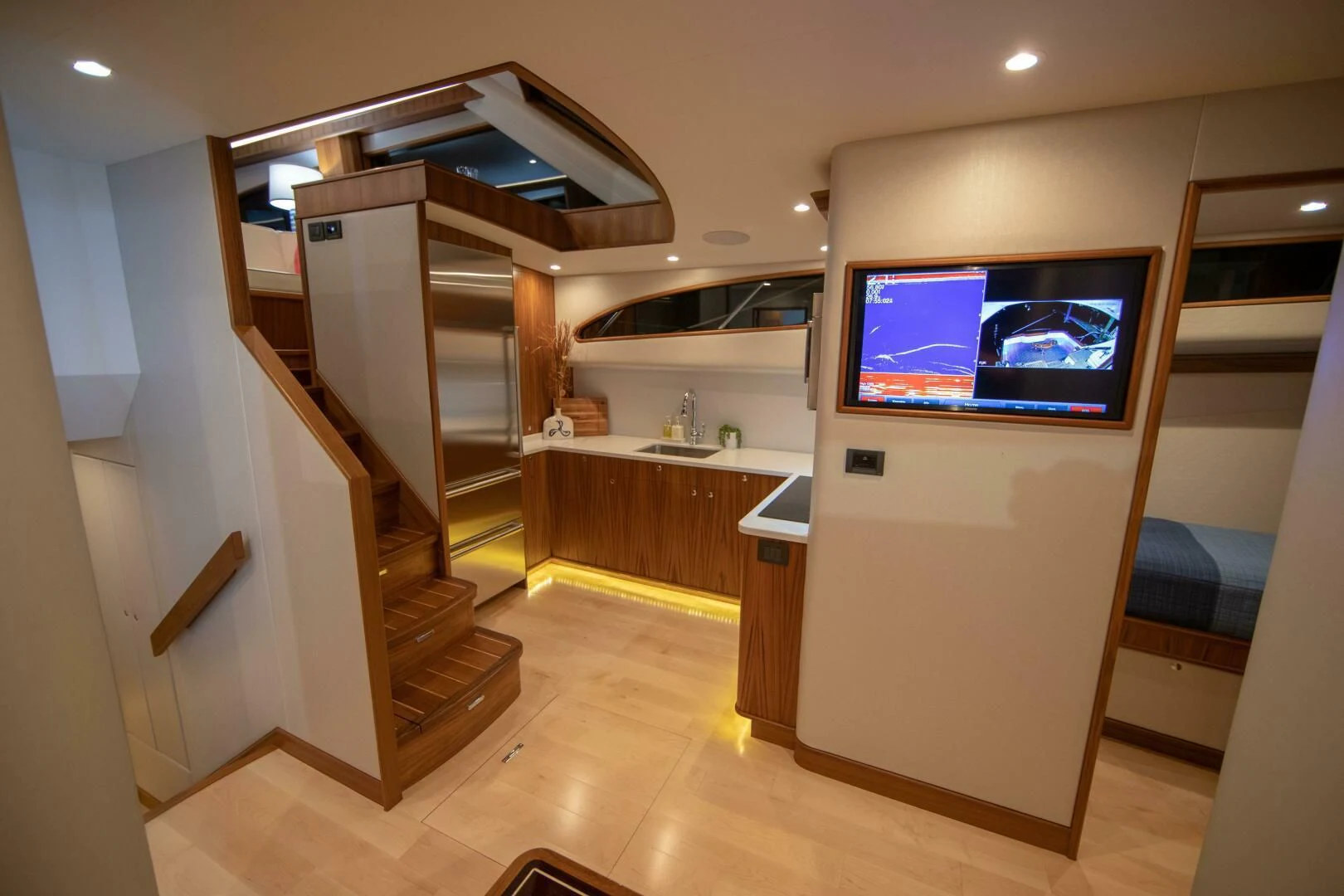 a room with a tv and a wood floor aboard PRIVATEER Yacht for Sale