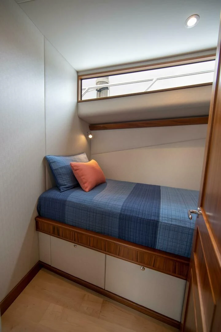 a bed with a blue blanket aboard PRIVATEER Yacht for Sale