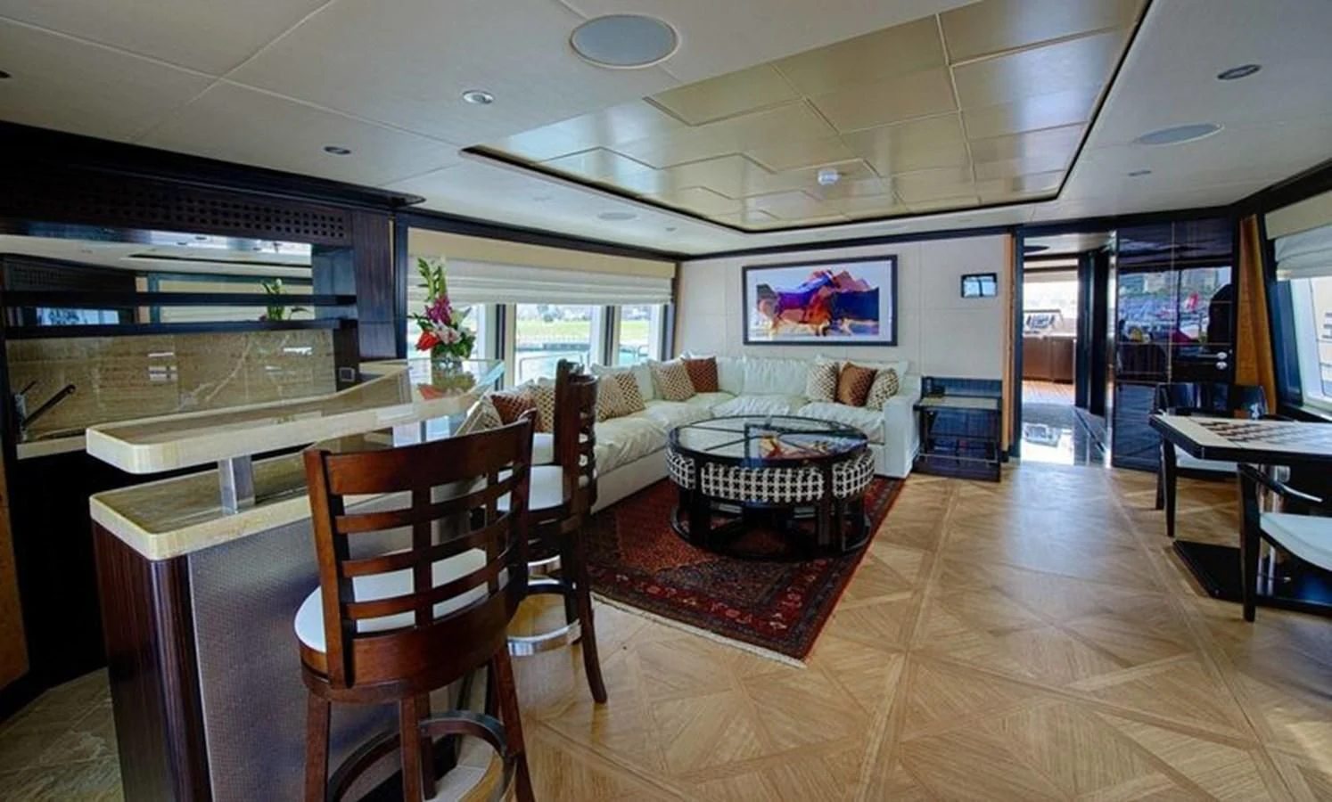 a living room with a wood floor aboard OCTOBER Yacht for Sale