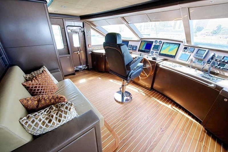 a person sitting in a chair in a control room aboard OCTOBER Yacht for Sale