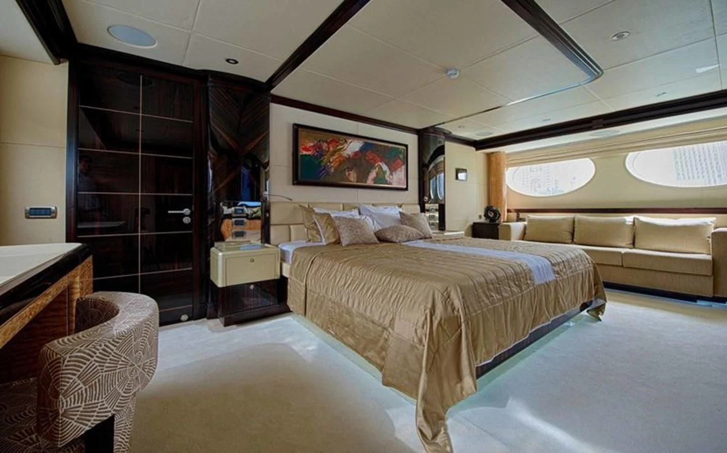 a room with a bed and a chair aboard OCTOBER Yacht for Sale