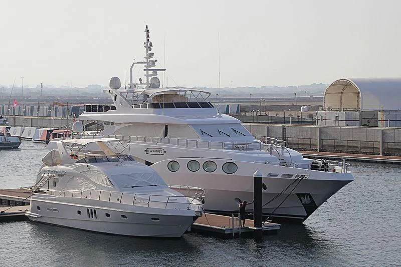 a large white boat in a harbor aboard OCTOBER Yacht for Sale