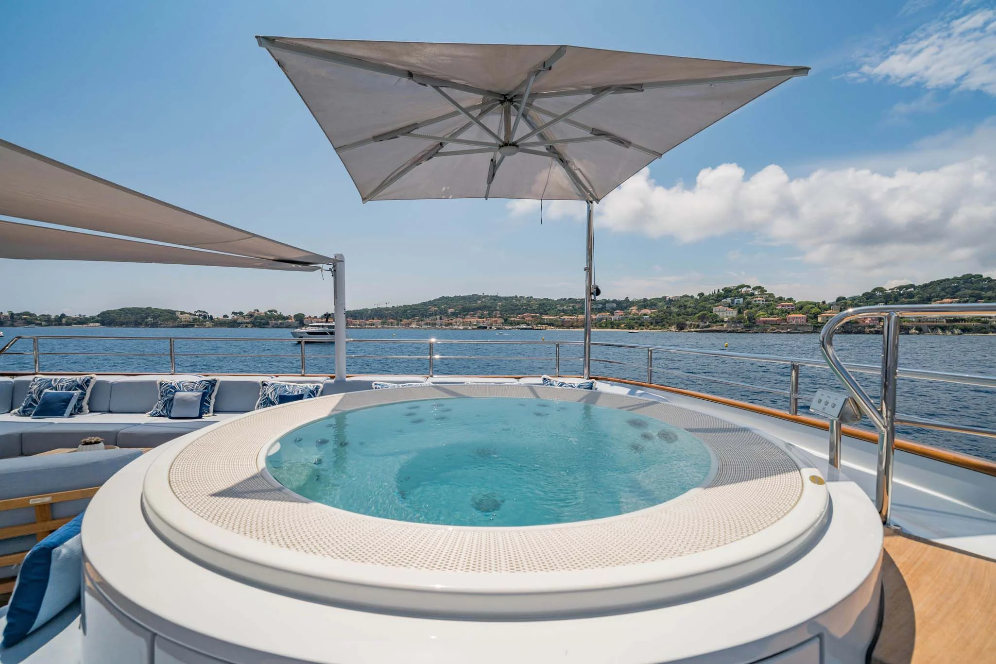 a pool with a large umbrella aboard SYNTHESIS 66 Yacht for Sale