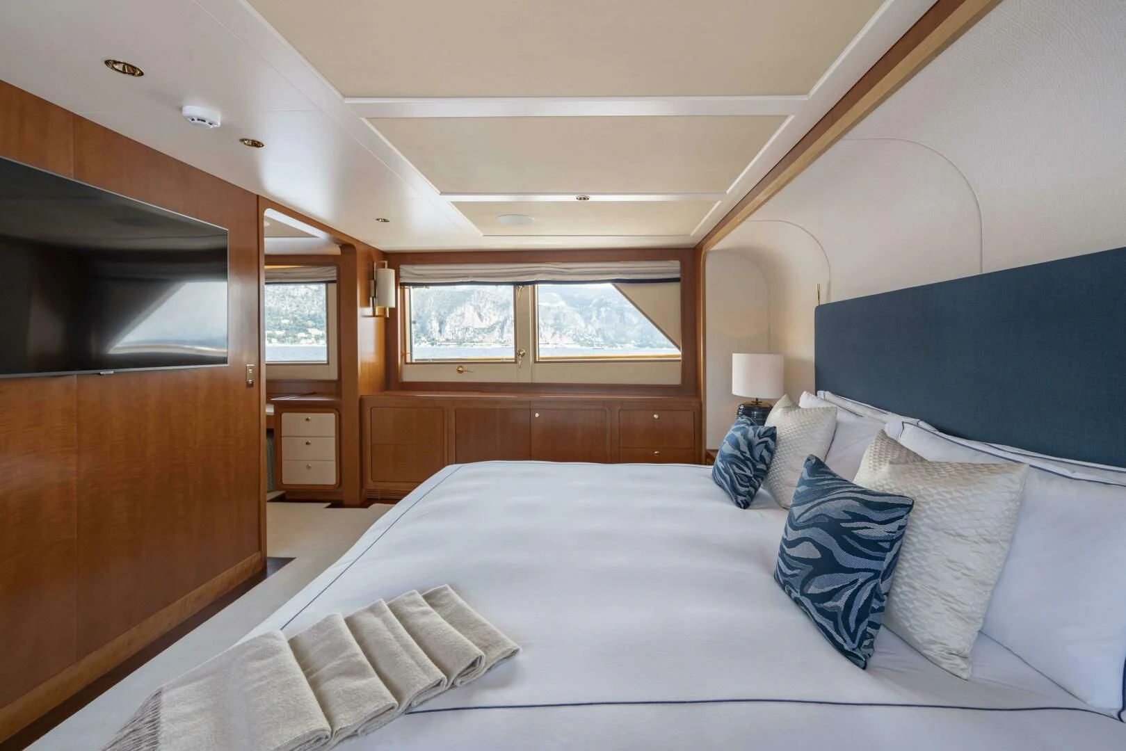 a bed with blue pillows aboard SYNTHESIS 66 Yacht for Sale