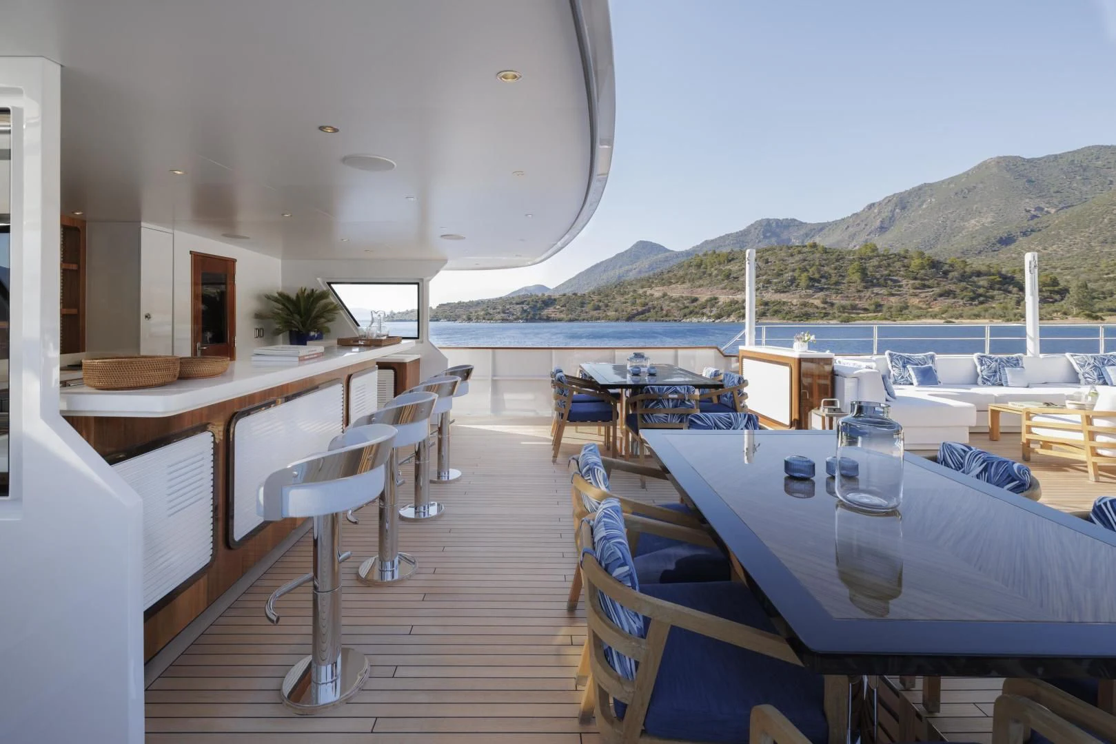 a boat dock with chairs and tables aboard SYNTHESIS 66 Yacht for Sale
