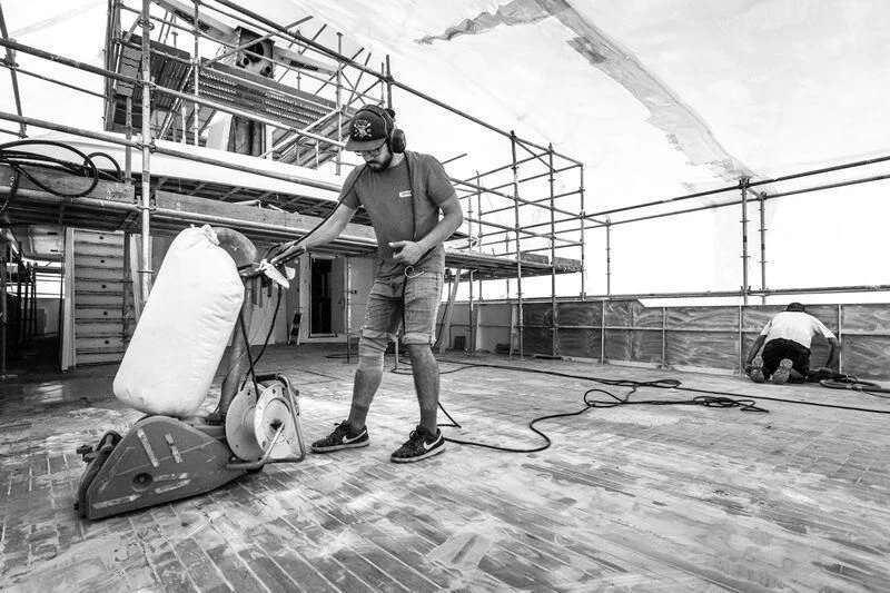 a man holding a baseball bat aboard SYNTHESIS 66 Yacht for Sale
