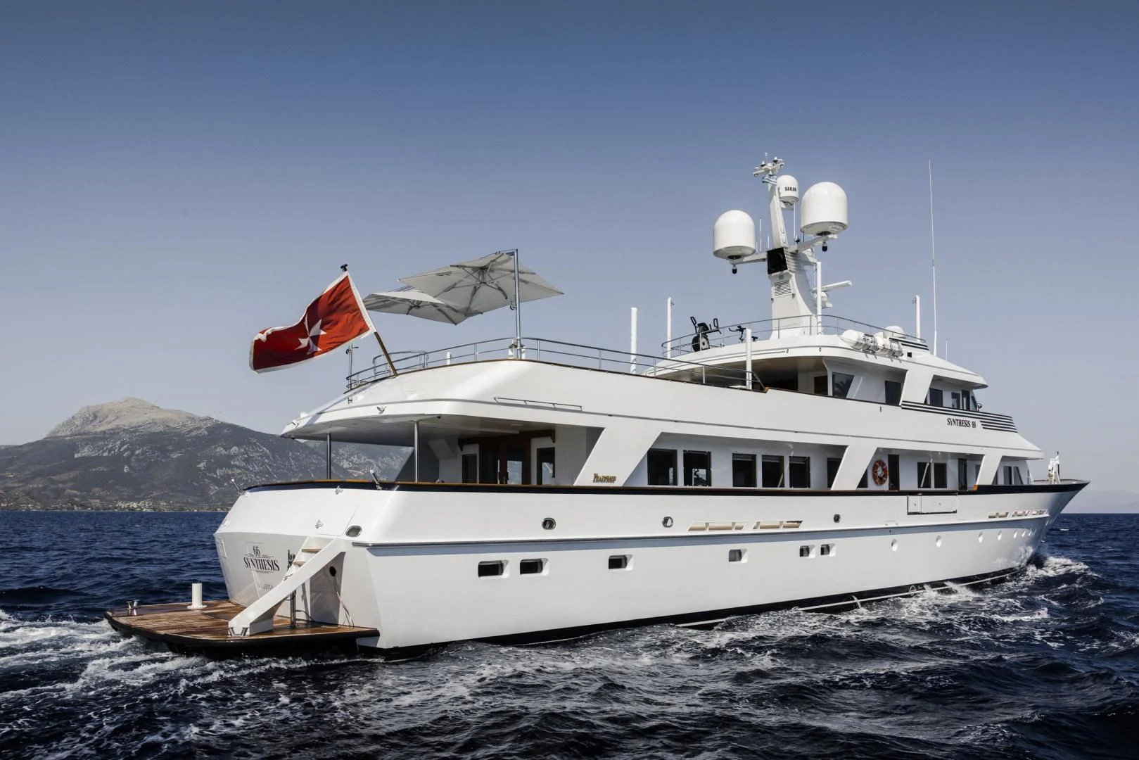 a large white boat on the water aboard SYNTHESIS 66 Yacht for Sale