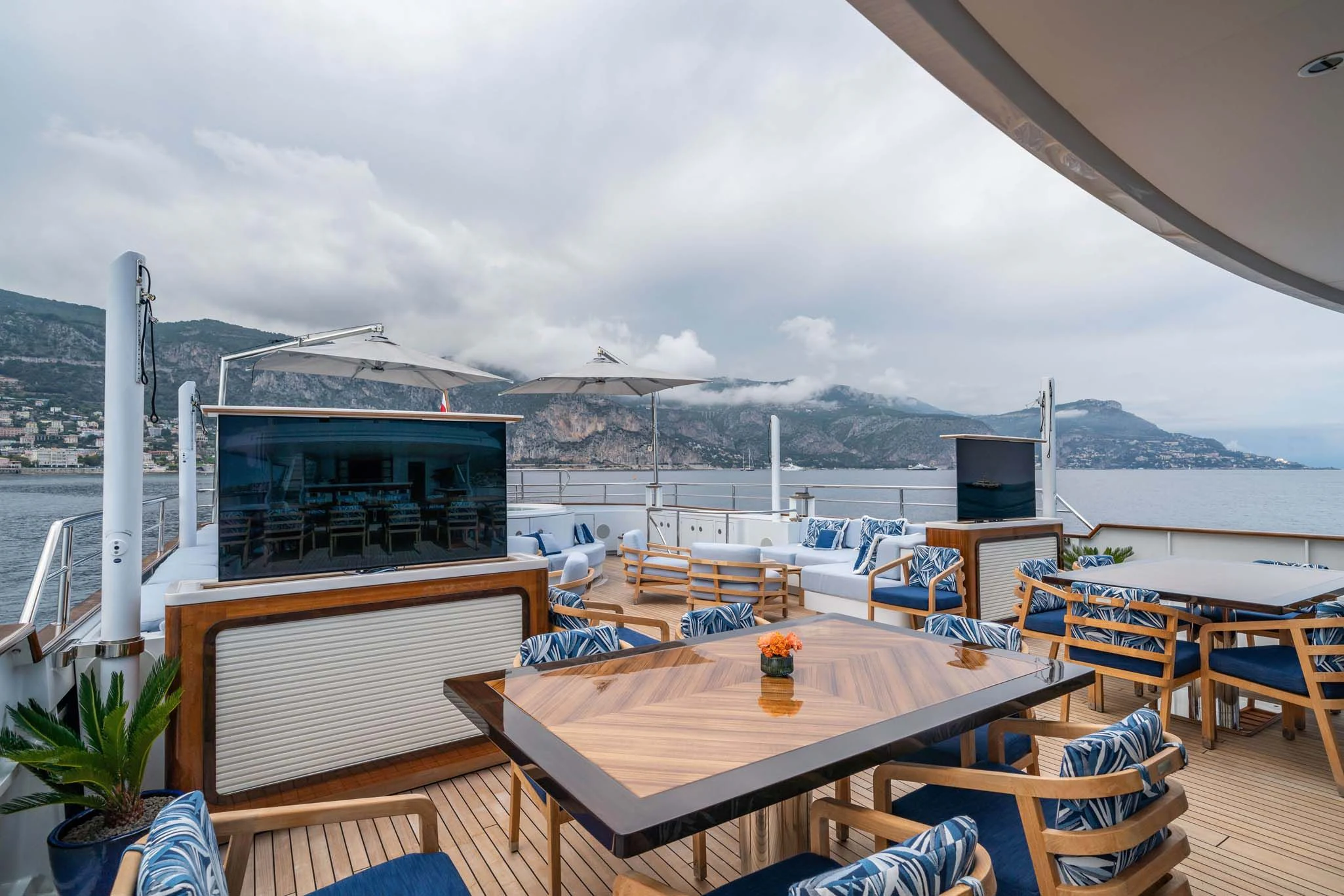 a deck with tables and chairs aboard SYNTHESIS 66 Yacht for Sale