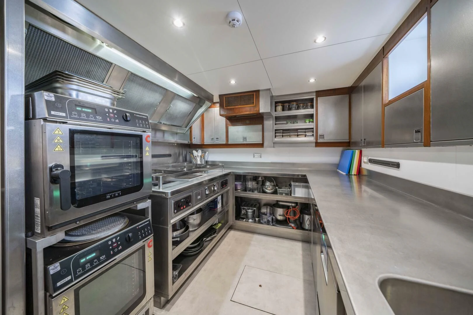 a kitchen with stainless steel appliances aboard SYNTHESIS 66 Yacht for Sale