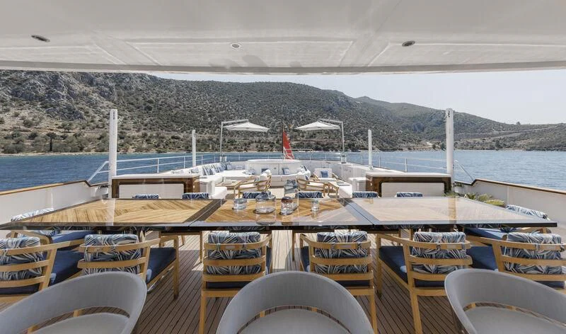a boat dock with chairs and umbrellas aboard SYNTHESIS 66 Yacht for Sale