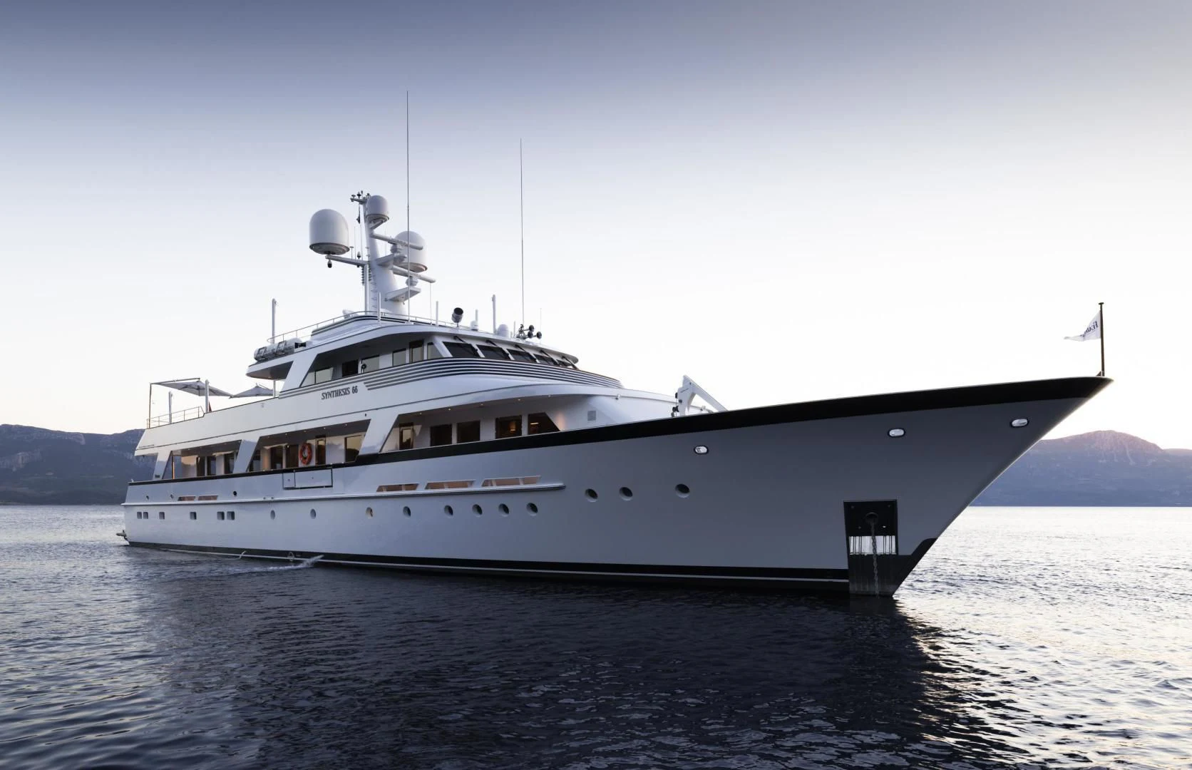a large white ship in the water aboard SYNTHESIS 66 Yacht for Sale