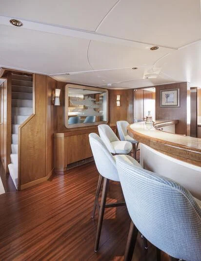 a room with a table chairs and a sink aboard SYNTHESIS 66 Yacht for Sale